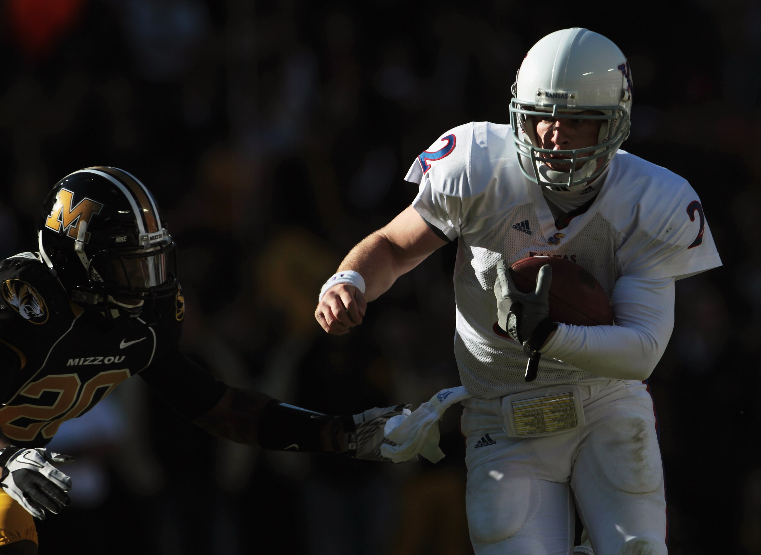 KANSAS CITY, MO - NOVEMBER 27:  Quarterback Jordan Webb #2 of the Kansas Jayhawks carries the ball into the endzone for a touchdown as Kevin Rutland #20 of the Missouri Tigers defends during the game on November 27, 2010 at Arrowhead Stadium in Kansas Cit