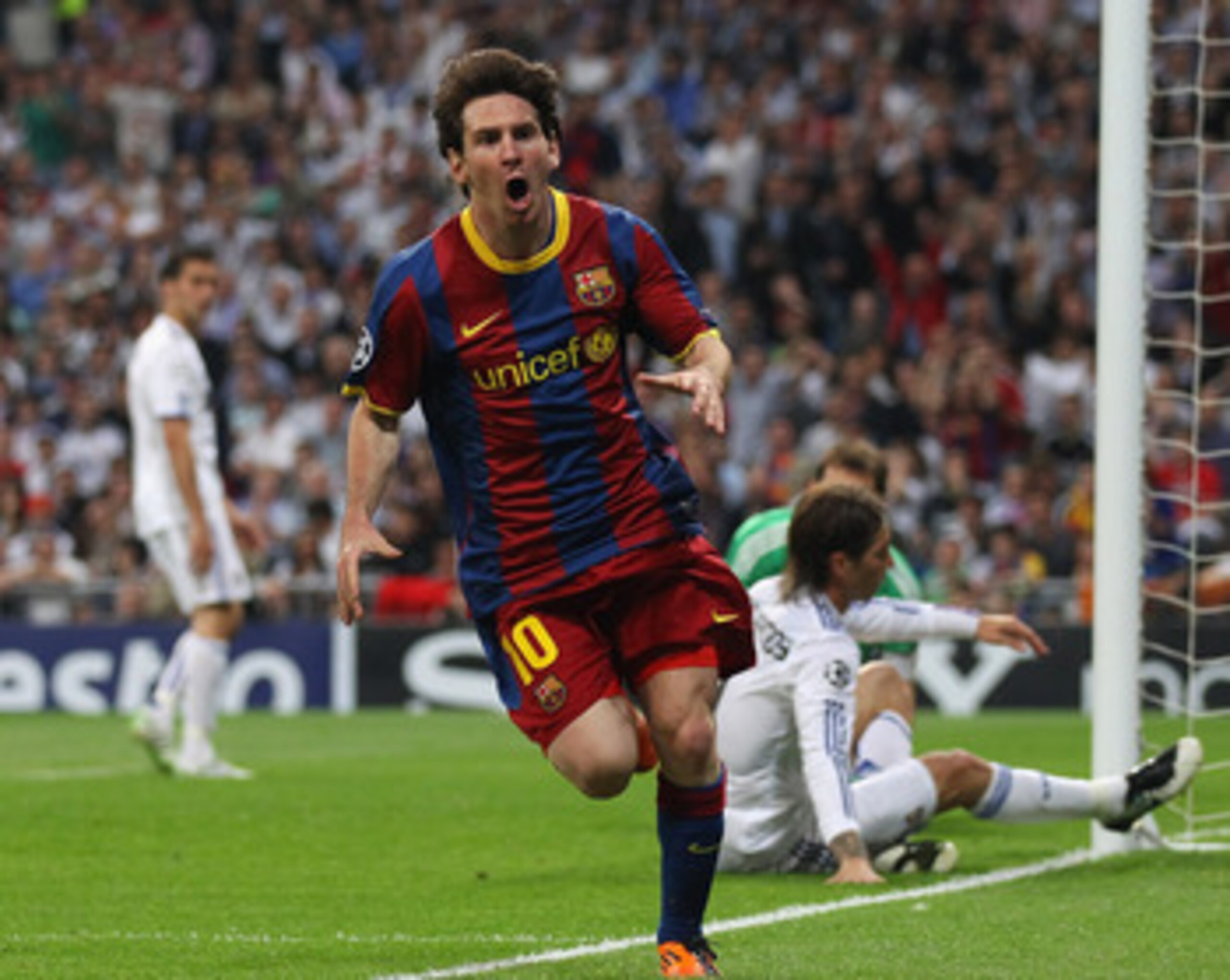 MADRID, SPAIN - APRIL 27: Lionel Messi of Barcelona celebrates after scoring his first goal during the UEFA Champions League Semi Final first leg match between Real Madrid and Barcelona at Estadio Santiago Bernabeu on April 27, 2011 in Madrid, Spain. (Pho