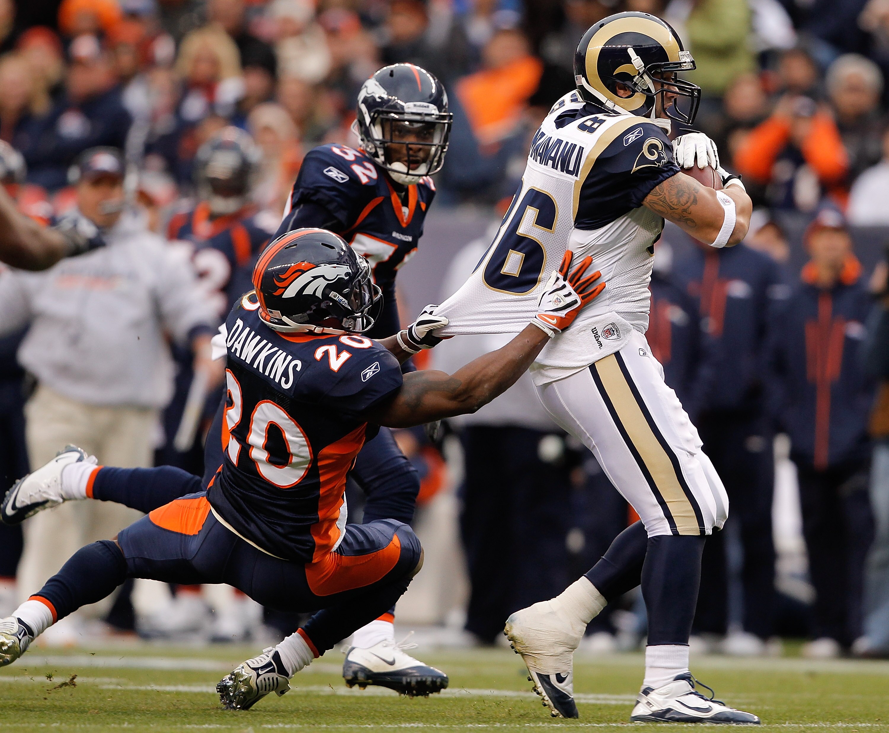 DENVER - NOVEMBER 28:  Tight end Michael Hoomanawanui #86 of the St. Louis Rams breaks away from safety Brian Dawkins #20 and Perrish Cox #32 of the Denver Broncos on his way to scoring a 36-yard touchdown in the first quarter at INVESCO Field at Mile Hig
