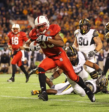 ORLANDO, FL - DECEMBER 28:  Mustafa Greene #33 of the North Carolina State Wolfpack scores a touchdown during the Champs Sports Bowl against the West Virginia Mountineers at Florida Citrus Bowl Stadium on December 28, 2010 in Orlando, Florida.  (Photo by