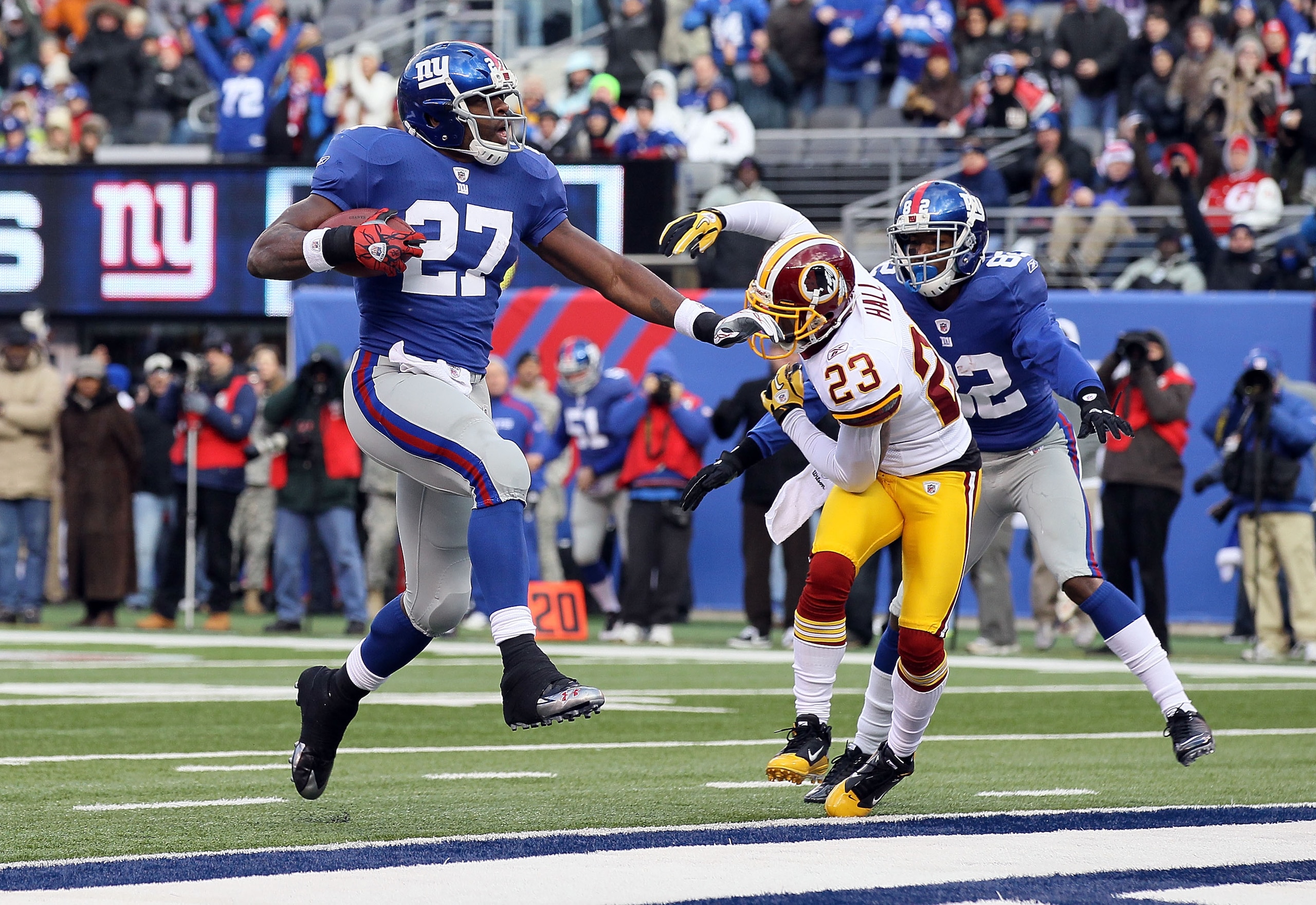 EAST RUTHERFORD, NJ - DECEMBER 05: Brandon Jacobs #27 of the New York Giants carries the ball past DeAngelo Hall #23 of the Washington Redskins into the endzone for a first quarter touchdown on December 5, 2010 at the New Meadowlands Stadium in East Ruth EAST RUTHERFORD, NJ - DECEMBER 05: Brandon Jacobs #27 of the New York Giants carries the ball past DeAngelo Hall #23 of the Washington Redskins into the endzone for a first quarter touchdown on December 5, 2010 at the New Meadowlands Stadium in East Ruth