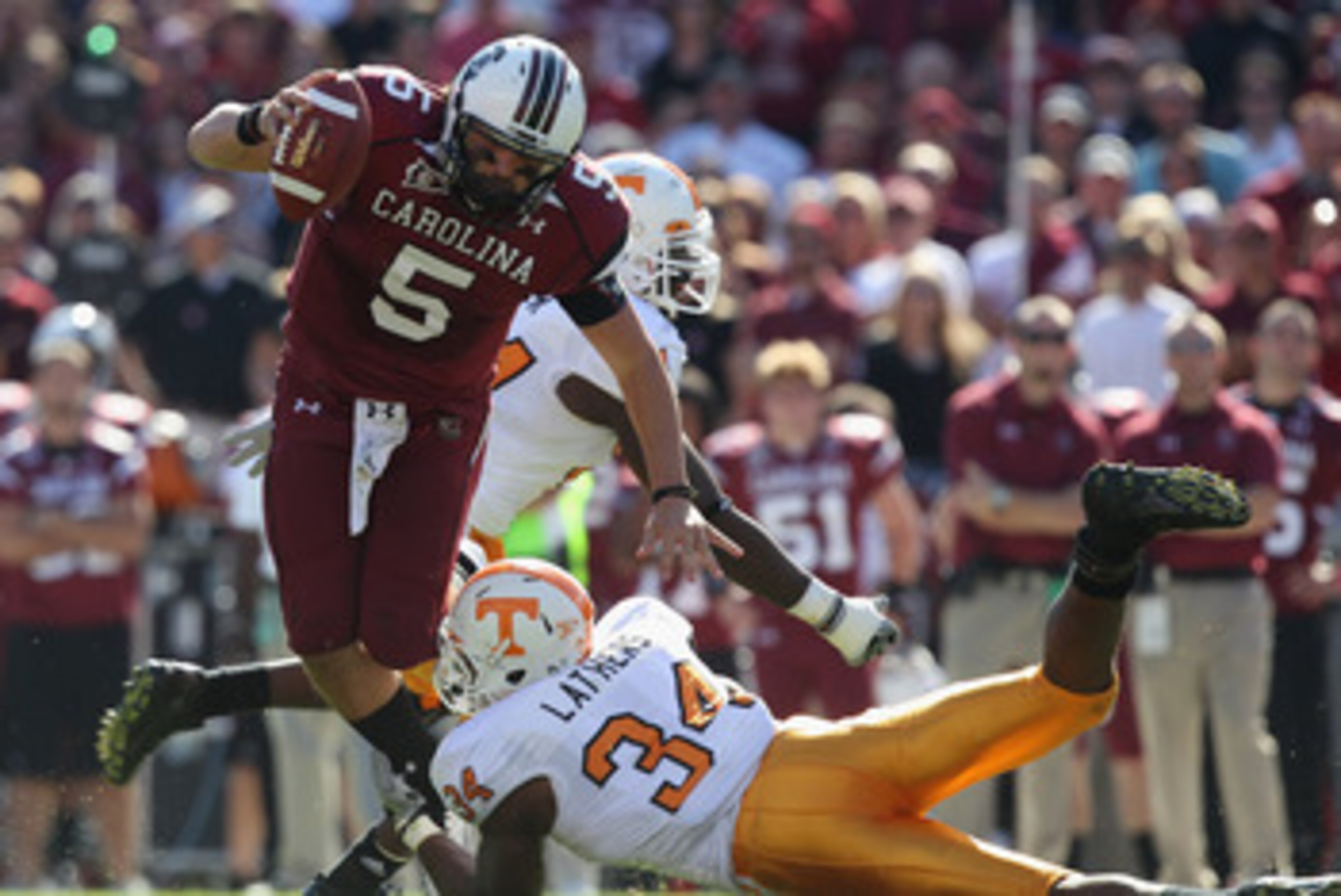 COLUMBIA, SC - OCTOBER 30:  Stephen Garcia #5 of the South Carolina Gamecocks gets away from Herman Lathers #34 of the Tennessee Volunteers during their game at Williams-Brice Stadium on October 30, 2010 in Columbia, South Carolina.  (Photo by Streeter Le
