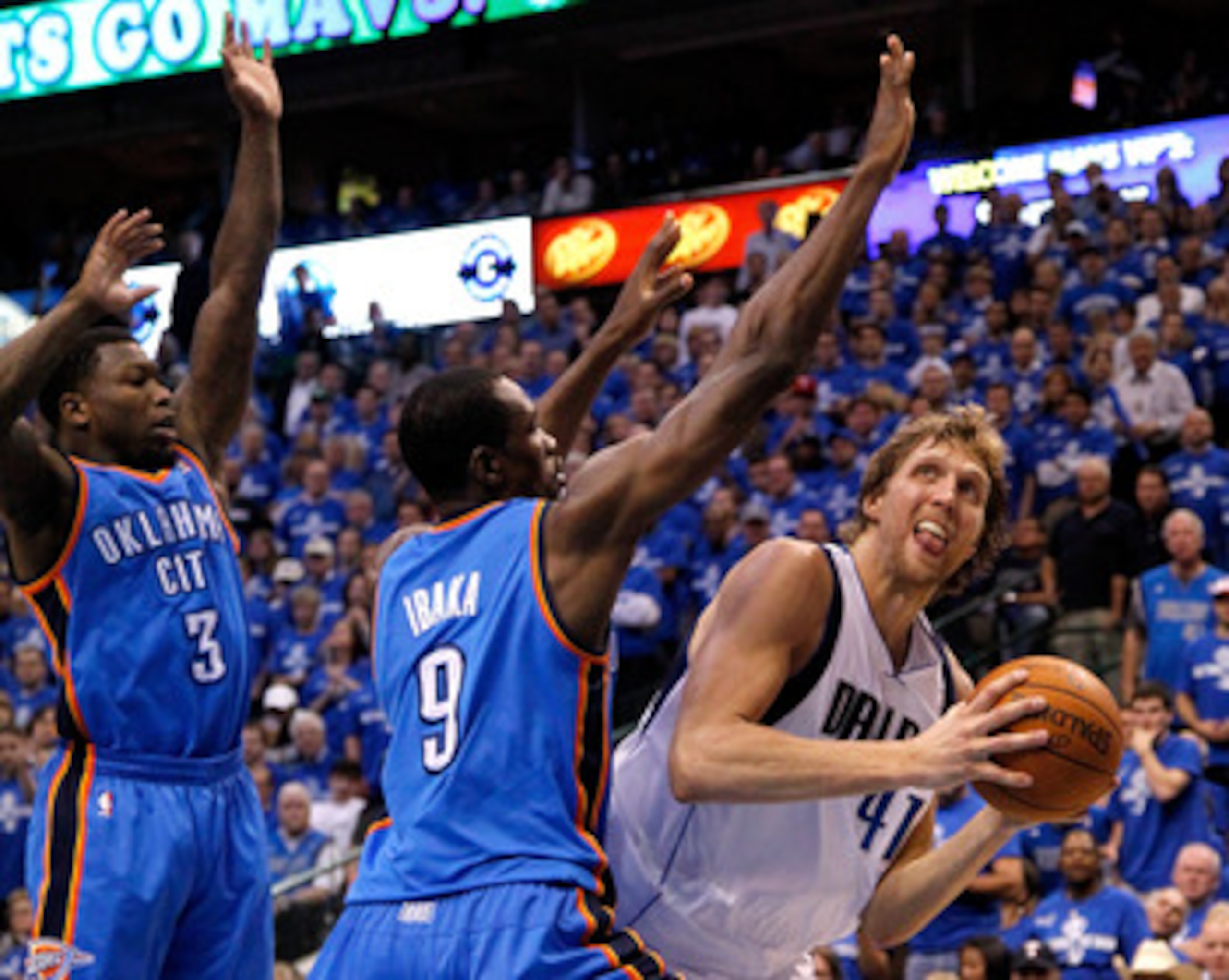 DALLAS, TX - MAY 17:  Dirk Nowitzki #41 of the Dallas Mavericks looks to shoot over Serge Ibaka #9 and Nate Robinson #3 of the Oklahoma City Thunder in Game One of the Western Conference Finals during the 2011 NBA Playoffs at American Airlines Center on M