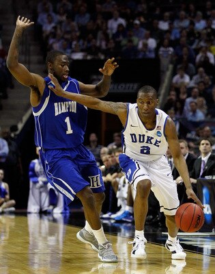 CHARLOTTE, NC - MARCH 18:  Nolan Smith #2 of the Duke Blue Devils moves the ball against Darrion Pellum #1 of the Hampton Pirates in the first half during the second round of the 2011 NCAA men's basketball tournament at Time Warner Cable Arena on March 18