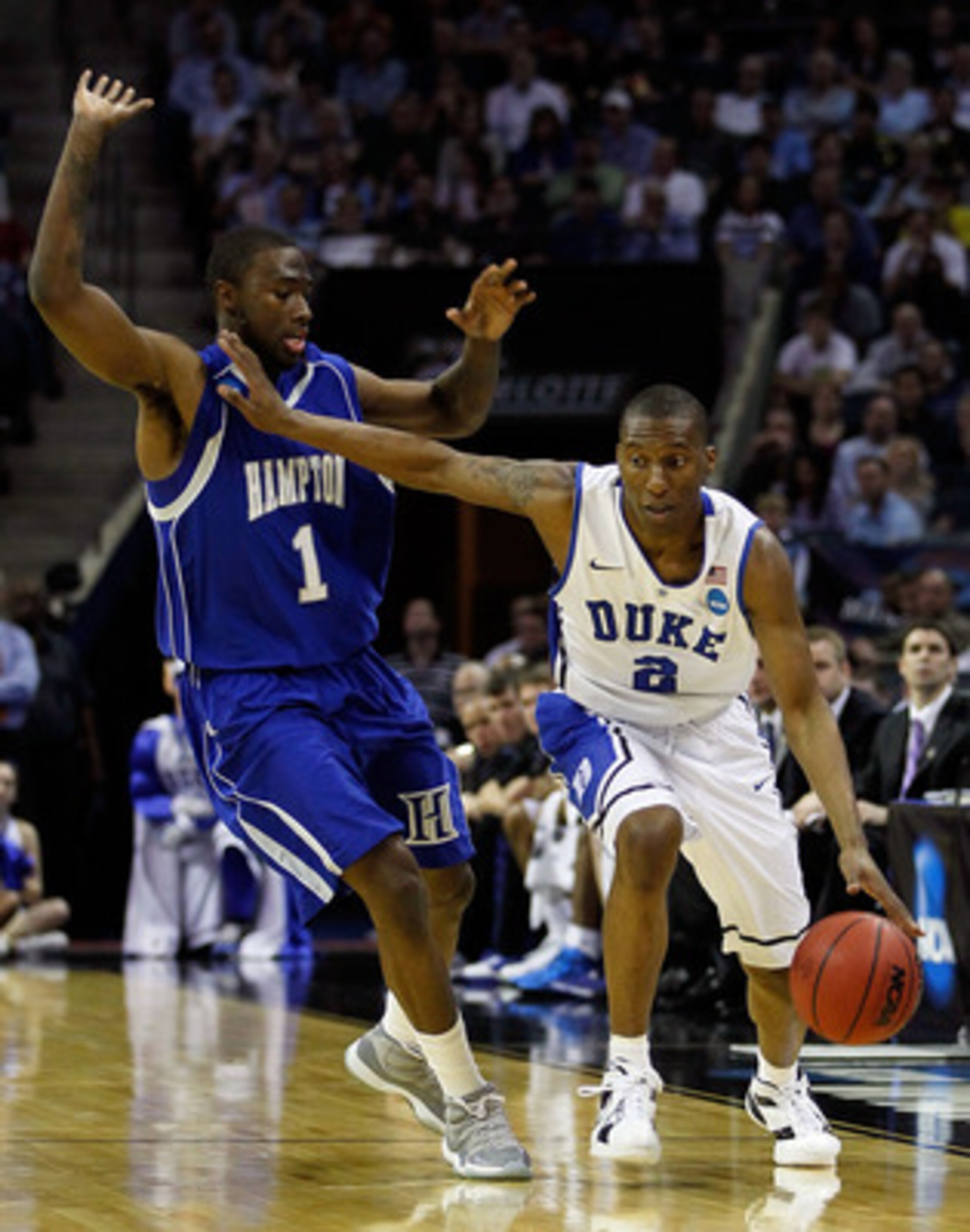 CHARLOTTE, NC - MARCH 18:  Nolan Smith #2 of the Duke Blue Devils moves the ball against Darrion Pellum #1 of the Hampton Pirates in the first half during the second round of the 2011 NCAA men's basketball tournament at Time Warner Cable Arena on March 18