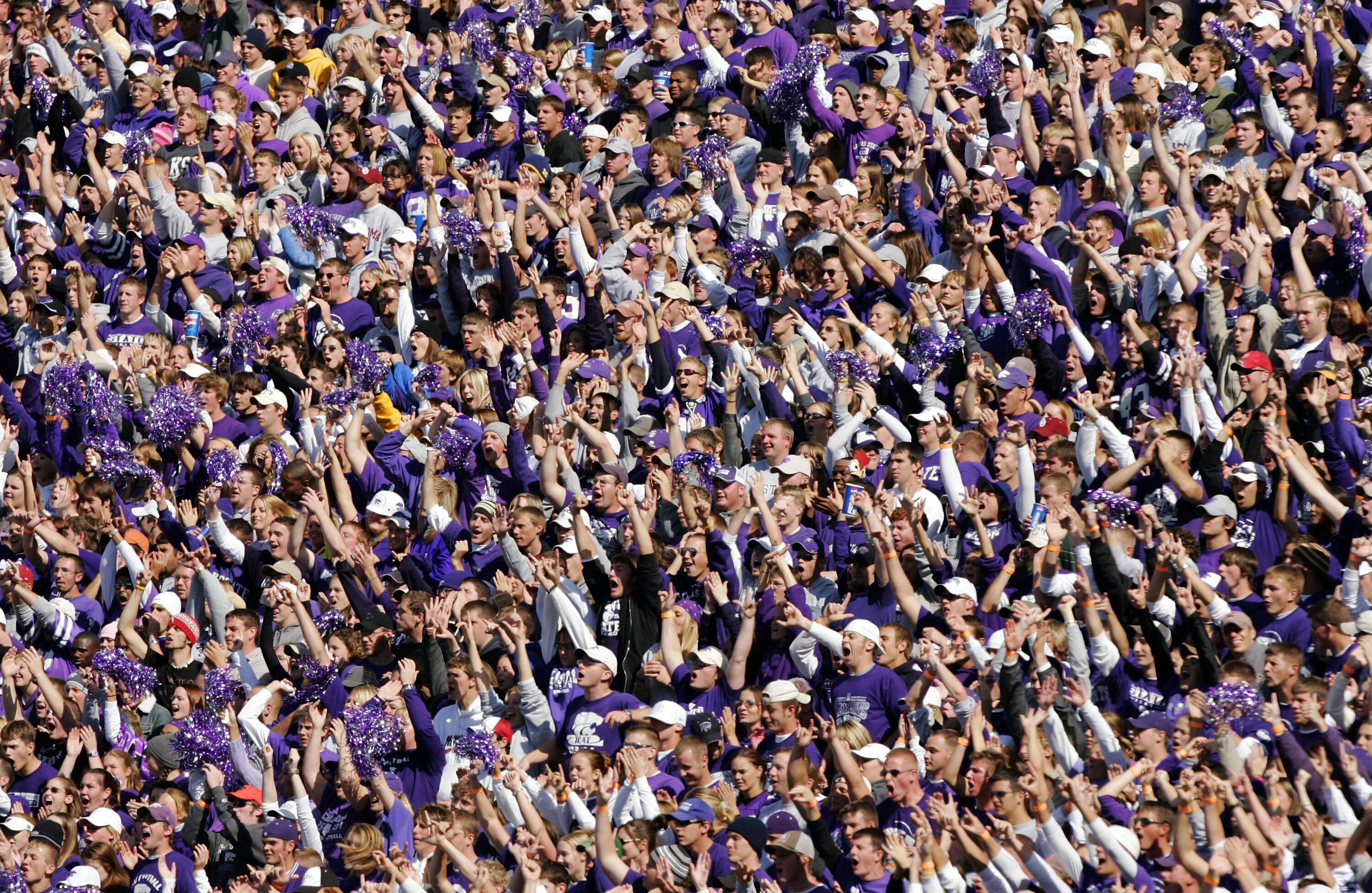 MANHATTAN, KS - OCTOBER 16:  Kansas State Wildcats fans cheer their team as they take a lead on an interception against the Oklahoma Sooners in the third quarter on October 16, 2004 at KSU Stadium in Manhattan, Kansas. The Sooners won 31-21.  (Photo by Br