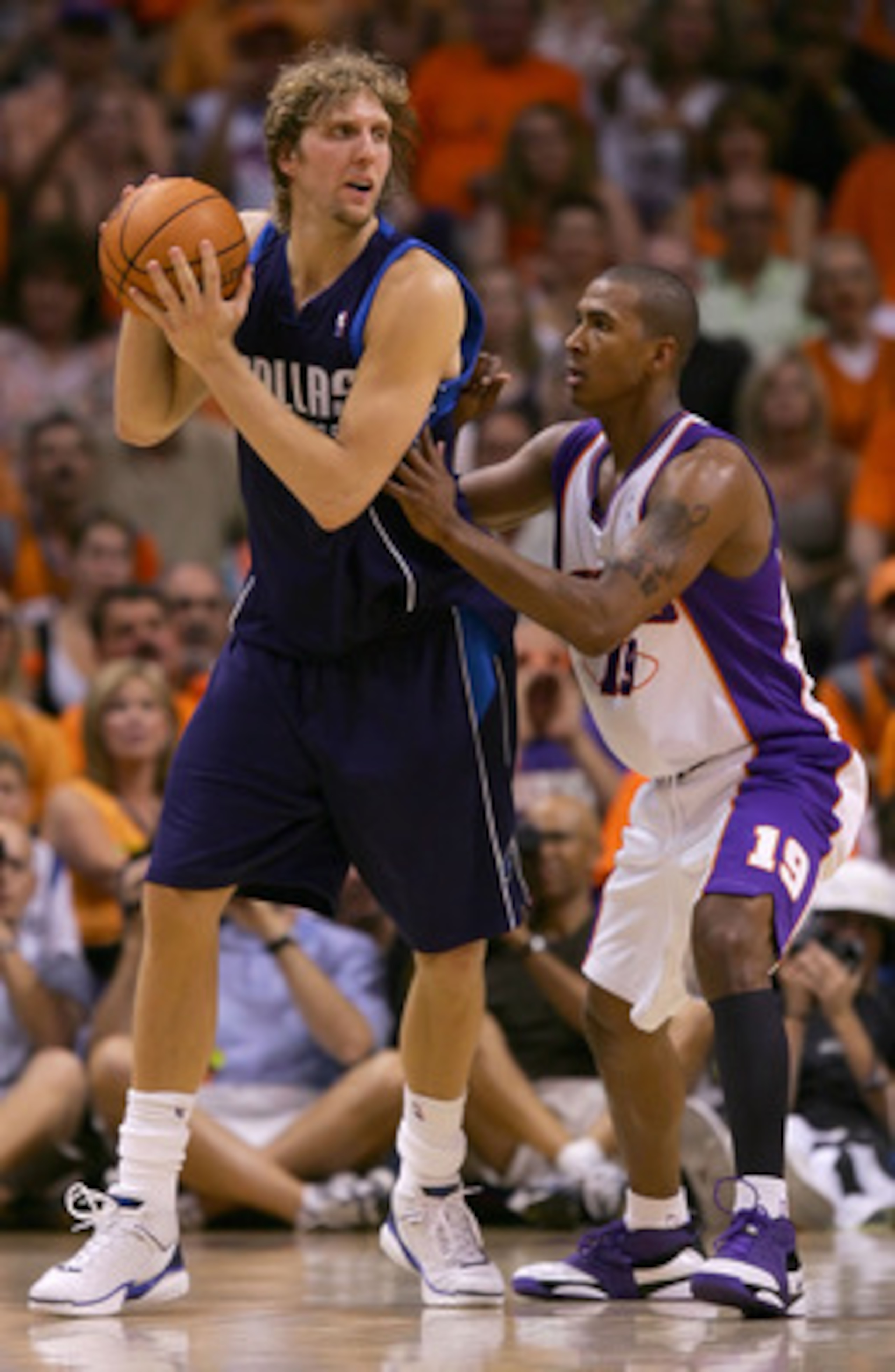 PHOENIX - JUNE 03:  Dirk Nowitzki #41 of the Dallas Mavericks looks to pass over Raja Bell #19 of the Phoenix Suns in game six of the Western Conference Finals during the 2006 NBA Playoffs on June 3, 2006 at US Airways Center in Phoenix, Arizona.  The Mav