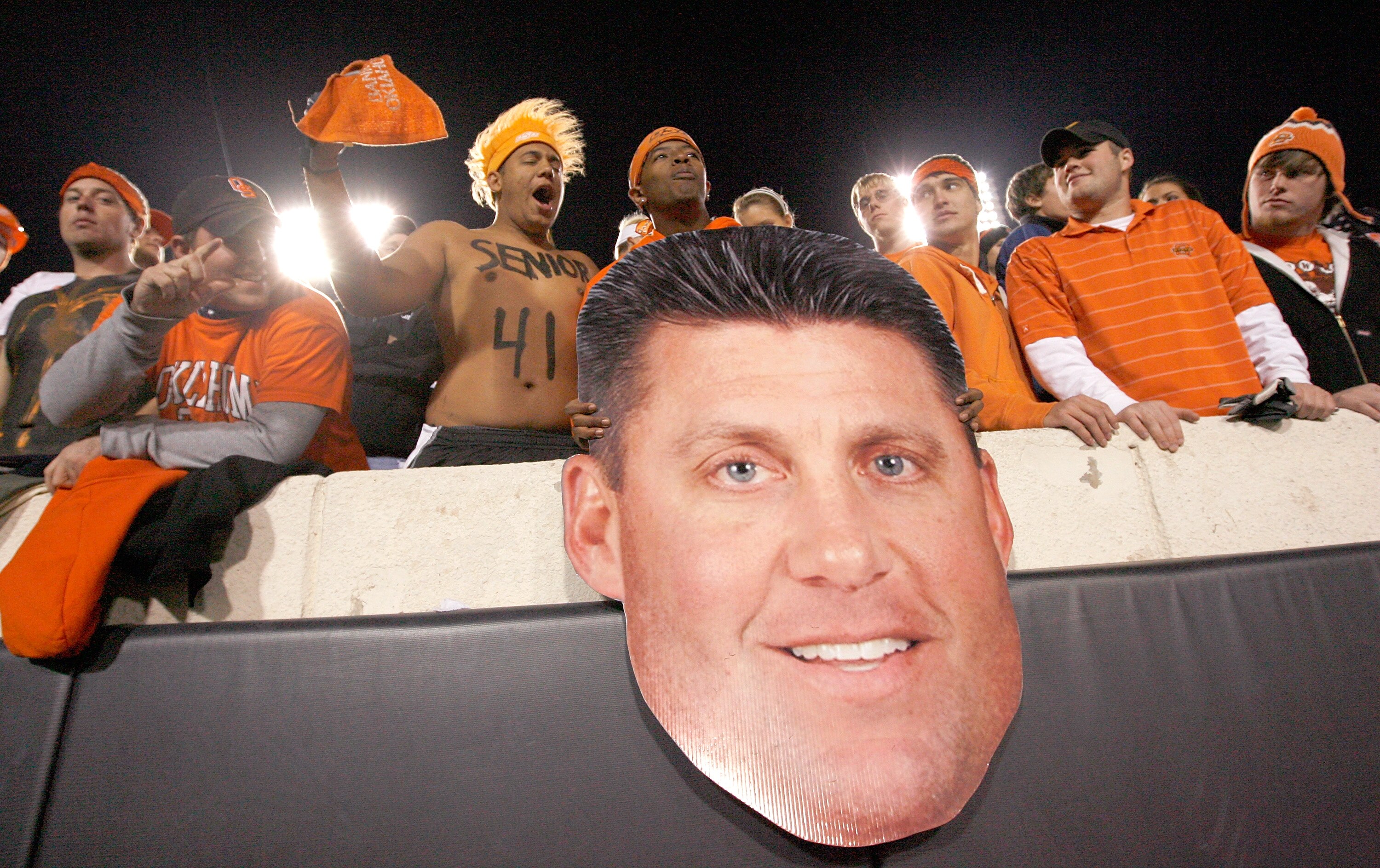 STILLWATER, OK - NOVEMBER 27:  Oklahoma State Cowboy fans cheer with a cardboard cutout of Oklahoma State head coach Mike Gundy as the Cowboys prepare to take on the Oklahoma Soones at Boone Pickens Stadium on November 27, 2010 in Stillwater, Oklahoma.  (