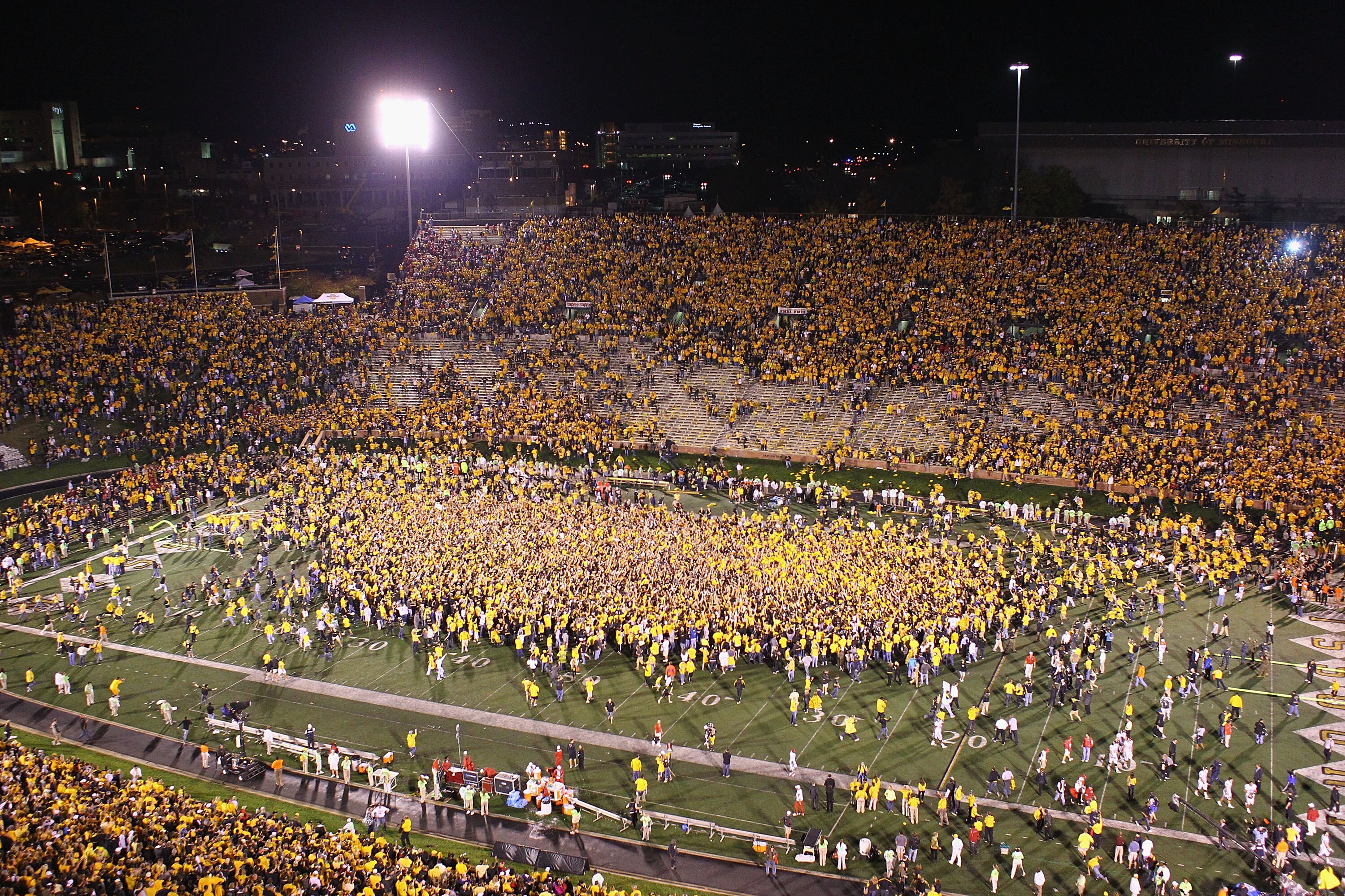 COLUMBIA, MISSOURI - OCTOBER 23: Missouri Tigers fans swarm the field after upsetting the Oklahoma Sooners at Faurot Field/Memorial Stadium on October 23, 2010 in Columbia, Missouri.  The Tigers beat the Sooners 36-27.  (Photo by Dilip Vishwanat/Getty Ima