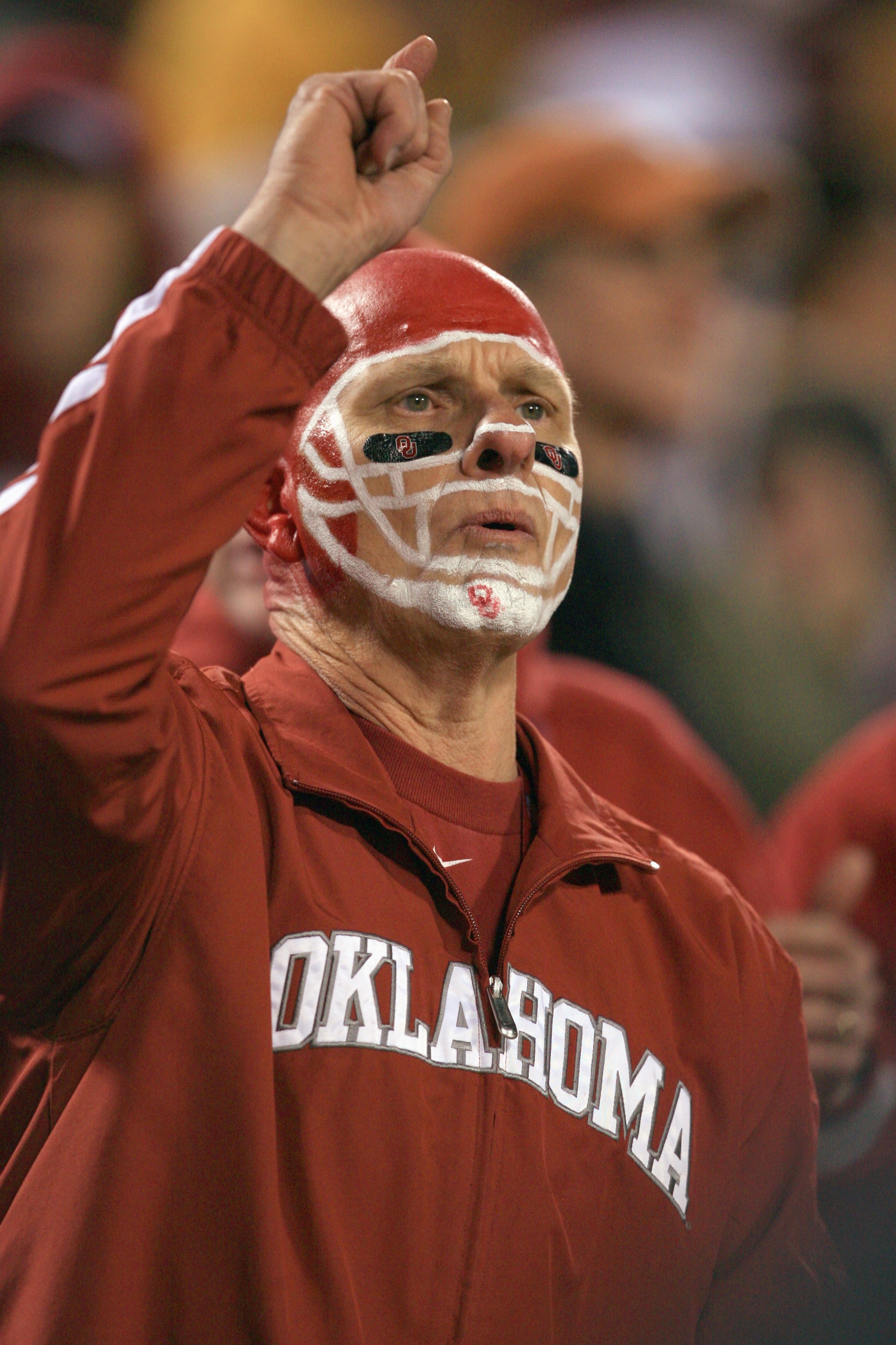 KANSAS CITY, MO - DECEMBER 06: An Oklahoma Sooners fan cheers during the Big 12 Championship game against the Missouri Tigers on December 6, 2008 at Arrowhead Stadium in Kansas City, Missouri. (Photo by Jamie Squire/Getty Images)