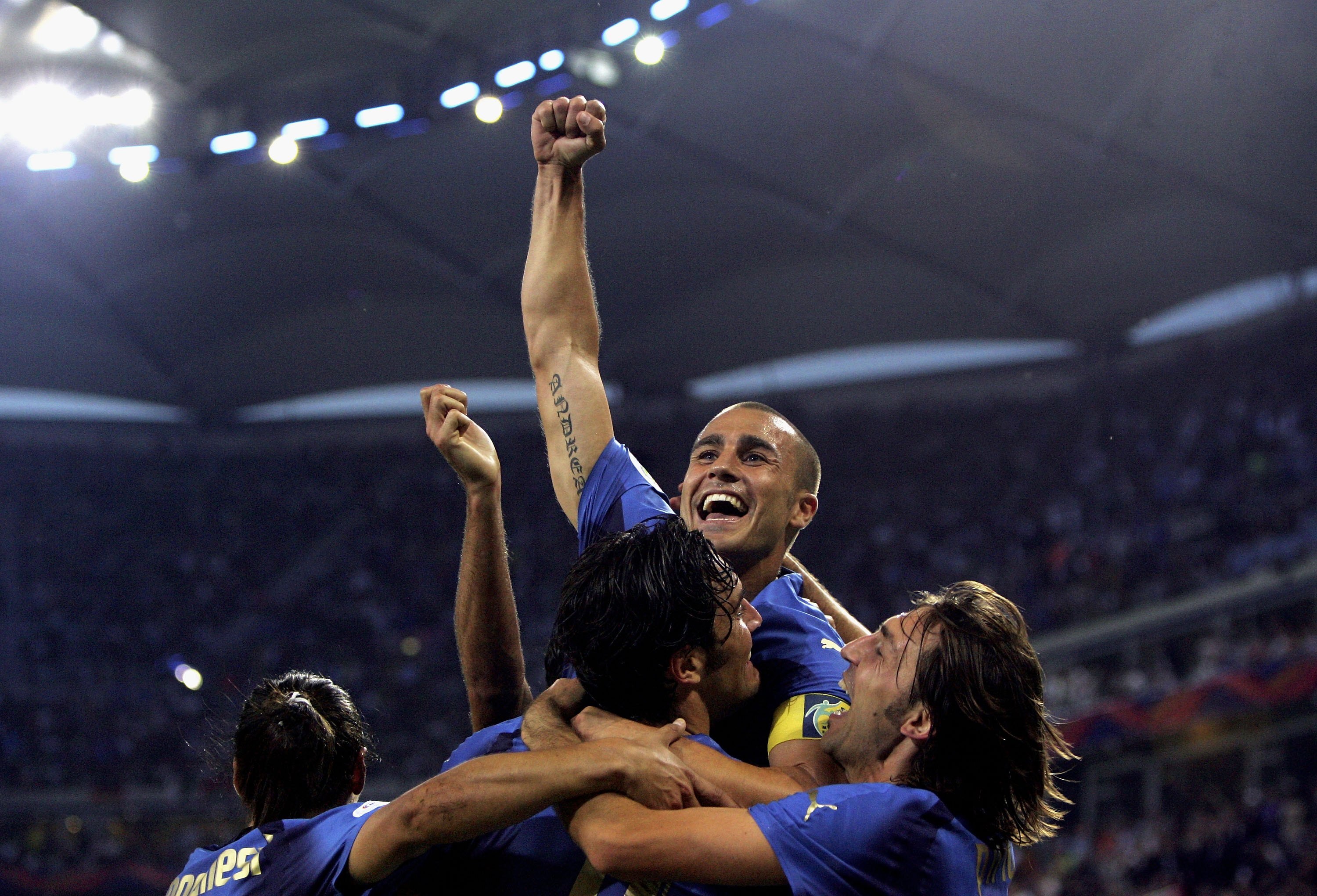 HAMBURG, GERMANY - JUNE 30:  Luca Toni (Bottom C) of Italy, celebrates with teammate Fabio Cannavaro (Top) and Andrea Pirlo, after scoring his team's second goal during the FIFA World Cup Germany 2006 Quarter-final match between Italy and Ukraine at the S