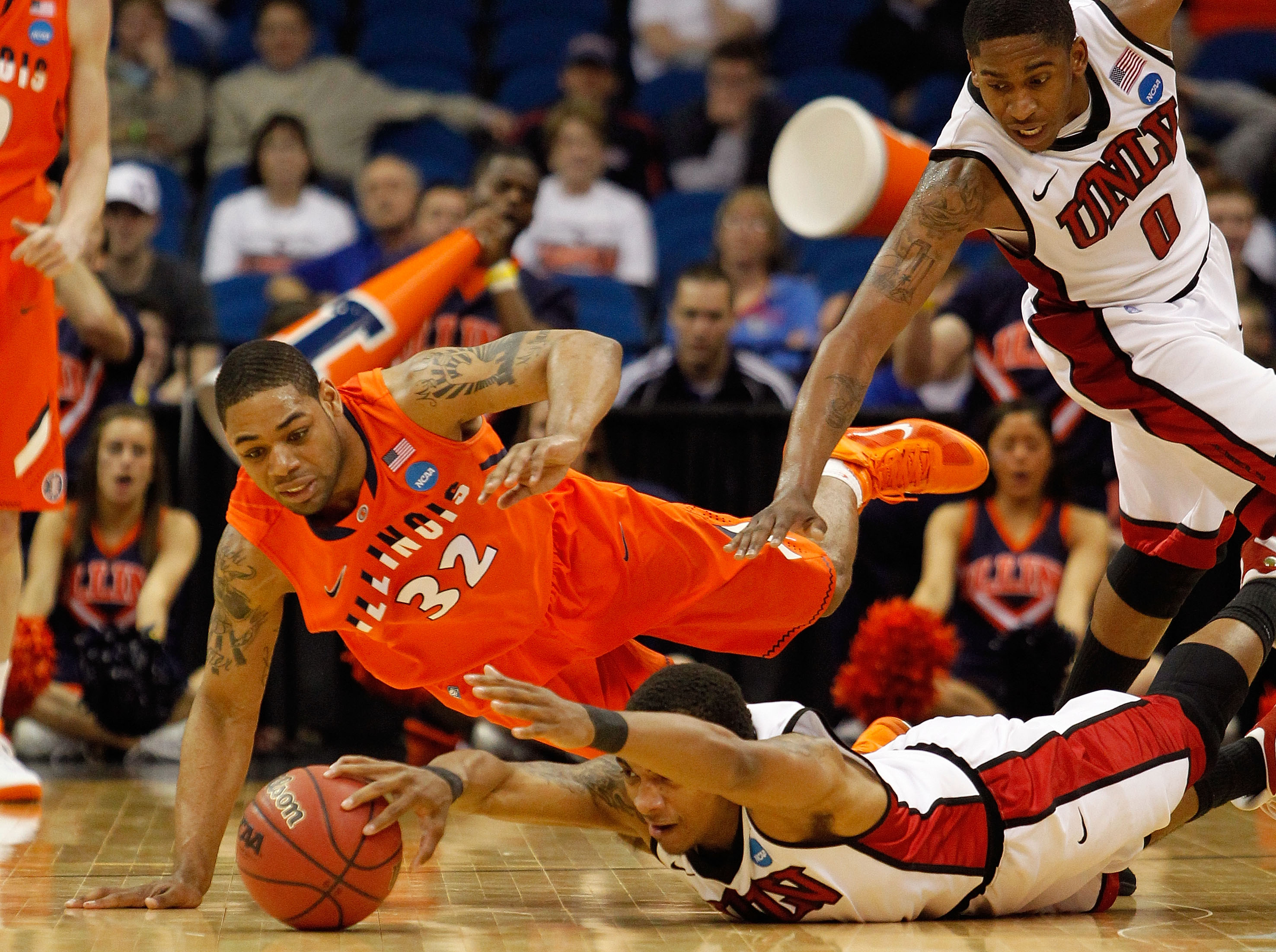 TULSA, OK - MARCH 18:  Anthony Marshall #3 of the UNLV Rebels and Demetri McCamey #32 of the Illinois Fighting Illini dive for a loose ball during the second round of the 2011 NCAA men's basketball tournament at BOK Center on March 18, 2011 in Tulsa, Okla