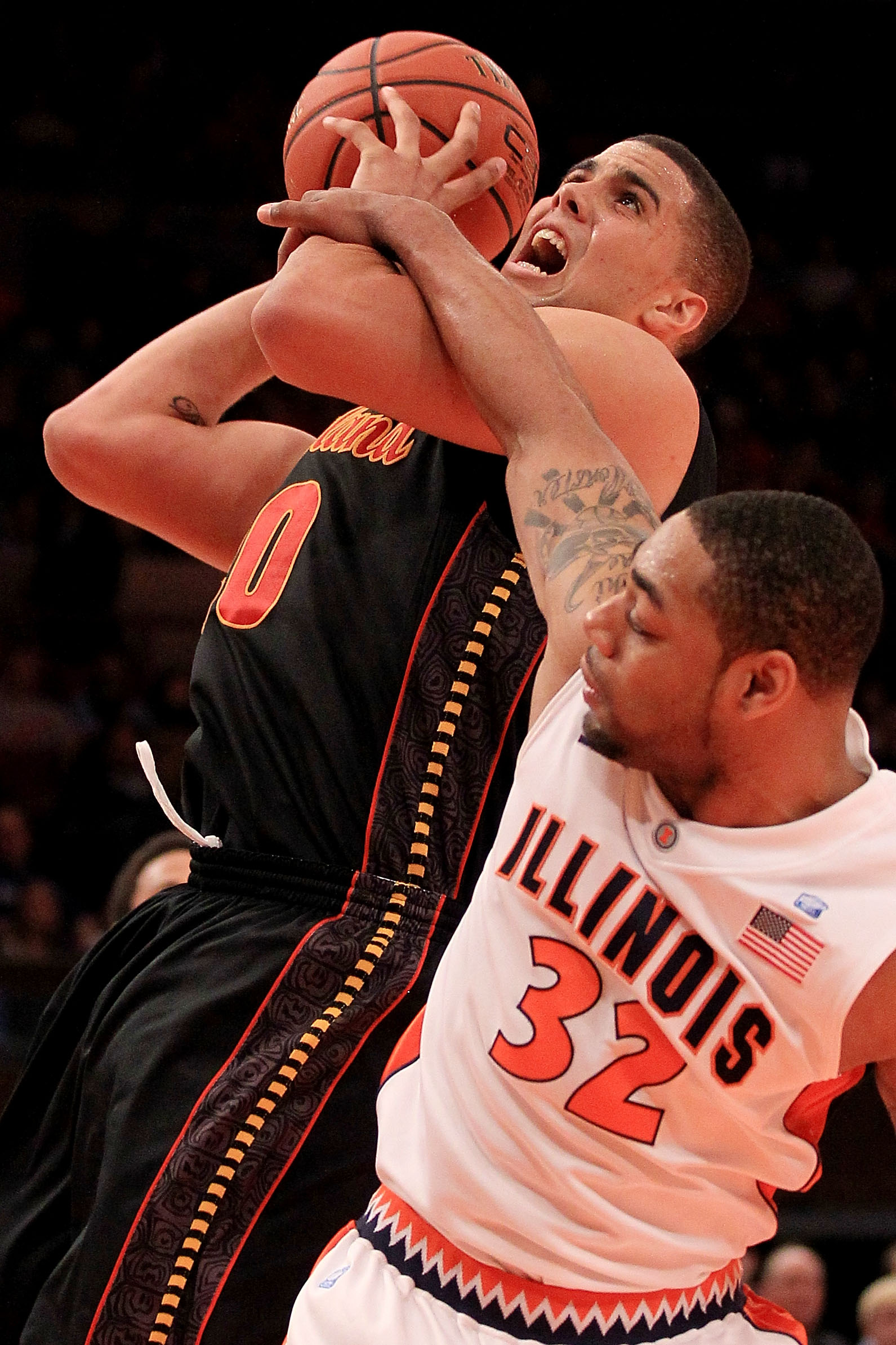 NEW YORK - NOVEMBER 19: Jordan Williams #20 of the Maryland Terrapins is fouled by Demetri McCamey #32 of the Illinois Fighting Illini during the 2k Sports Classic at Madison Square Garden on November 19, 2010 in New York, New York.  (Photo by Chris McGra