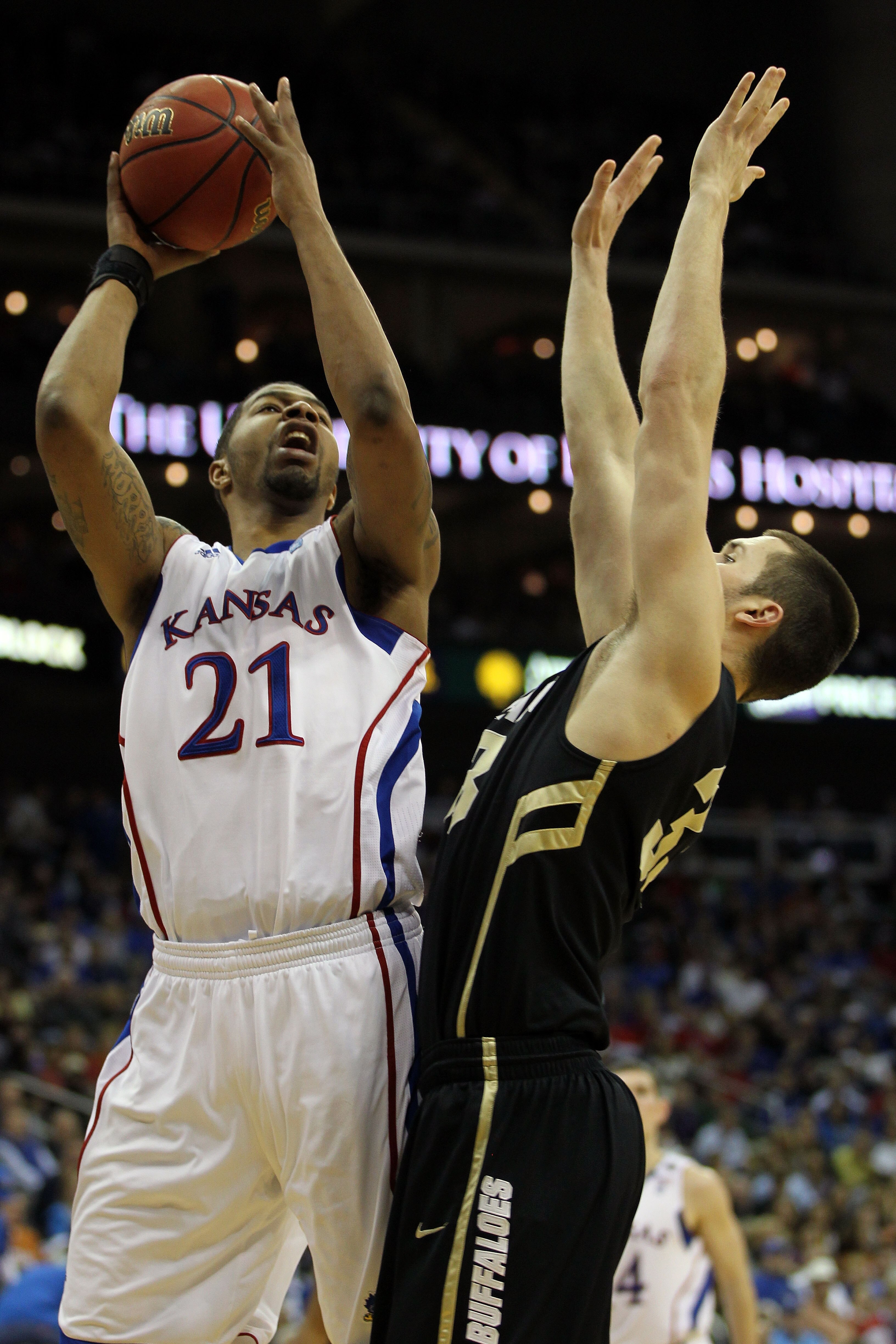 KANSAS CITY, MO - MARCH 11:  Markieff Morris #21 of the Kansas Jayhawks goes up for a shot against Austin Dufault #33 of the Colorado Buffaloes during their semifinal game in the 2011 Phillips 66 Big 12 Men's Basketball Tournament at Sprint Center on Marc