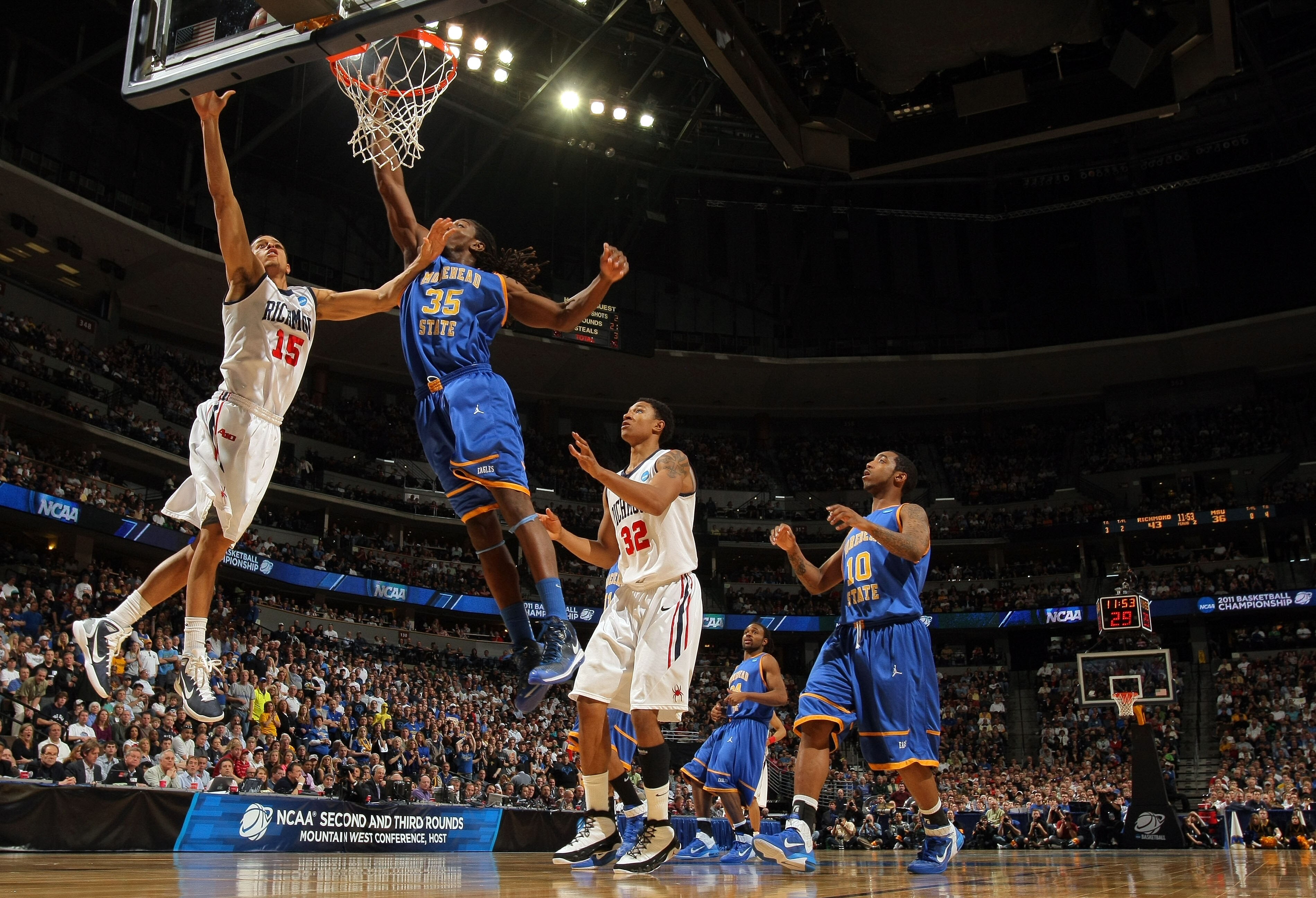 DENVER, CO - MARCH 19:  Francis-Cedric Martel #15 of the Richmond Spiders goes to the hoop against Kenneth Faried #35 of the Morehead State Eagles during the third round of the 2011 NCAA men's basketball tournament at Pepsi Center on March 19, 2011 in Den