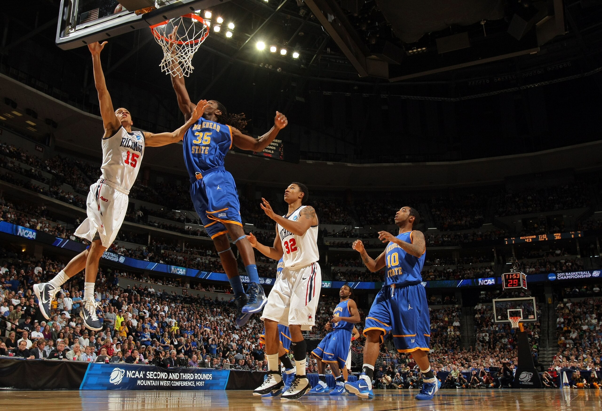 DENVER, CO - MARCH 19:  Francis-Cedric Martel #15 of the Richmond Spiders goes to the hoop against Kenneth Faried #35 of the Morehead State Eagles during the third round of the 2011 NCAA men's basketball tournament at Pepsi Center on March 19, 2011 in Den