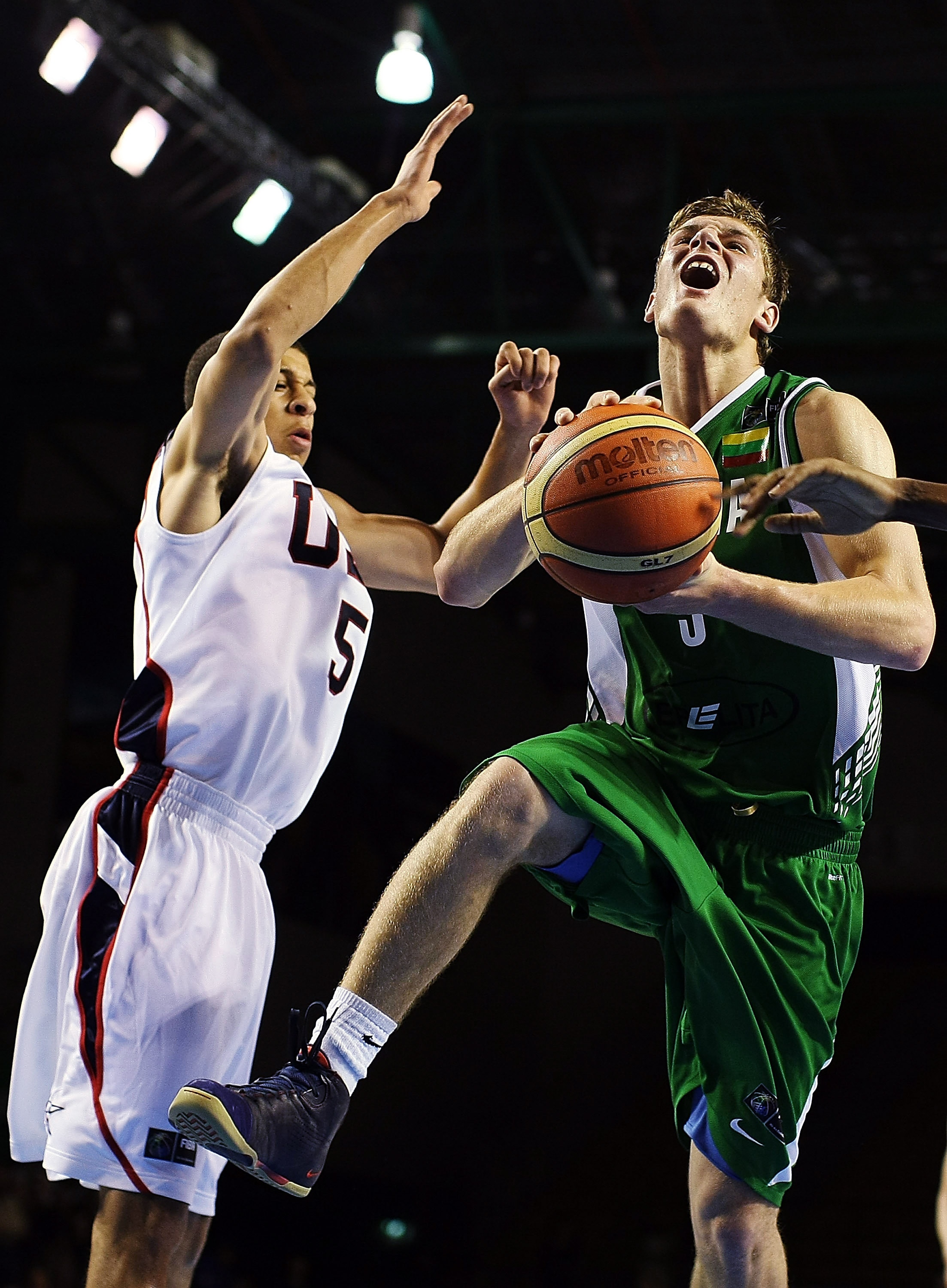 AUCKLAND, NEW ZEALAND - JULY 08:  Donatas Motiejunas of Lithuania takes the ball to the hoop as Seth Curry of the United States defends during the U19 Basketball World Championships match between the United States and Lithuania at North Shore Events Centr