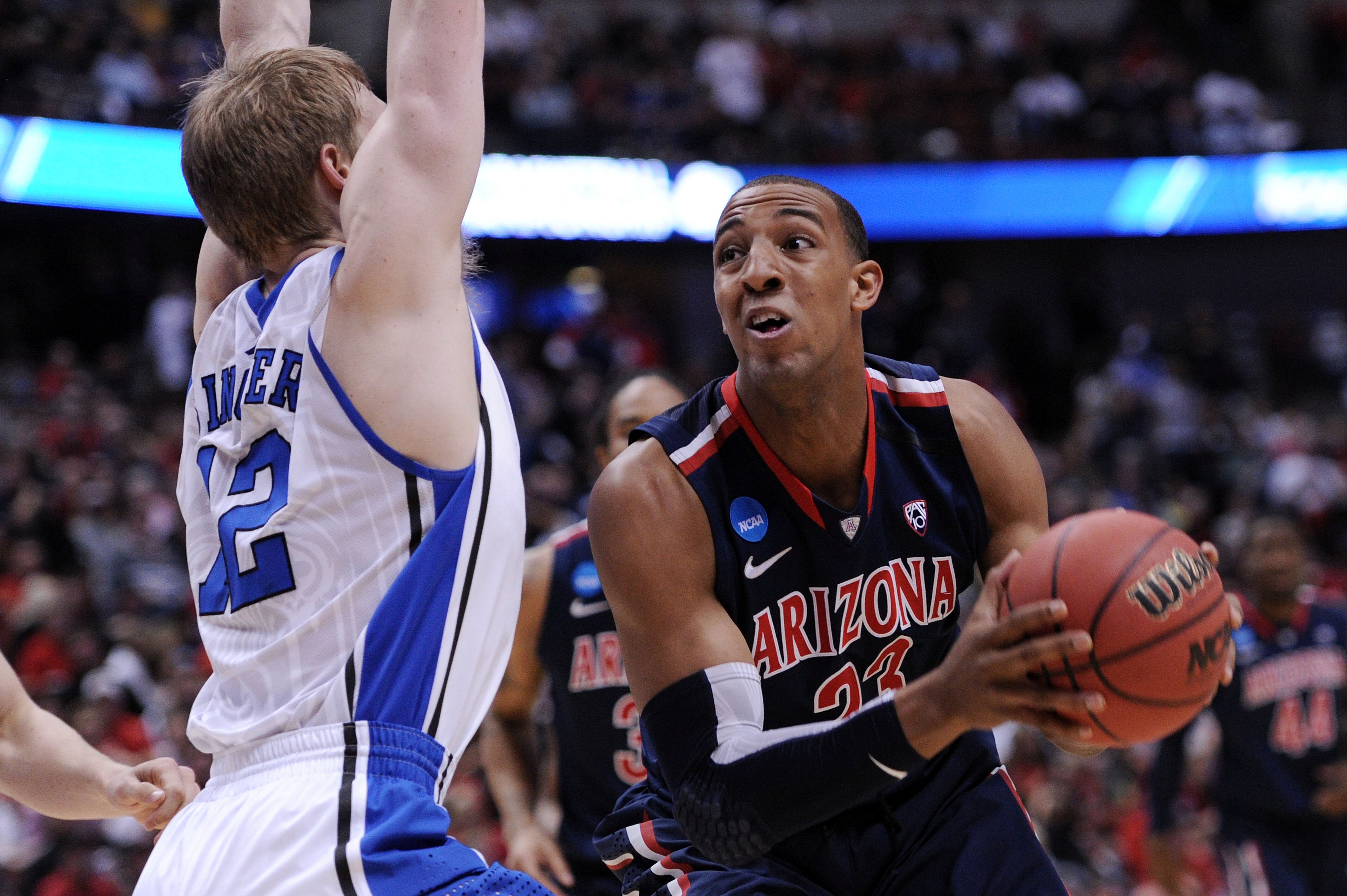ANAHEIM, CA - MARCH 24:  Derrick Williams #23 of the Arizona Wildcats handles the ball against Kyle Singler #12 of the Duke Blue Devils  during the west regional semifinal of the 2011 NCAA men's basketball tournament at the Honda Center on March 24, 2011