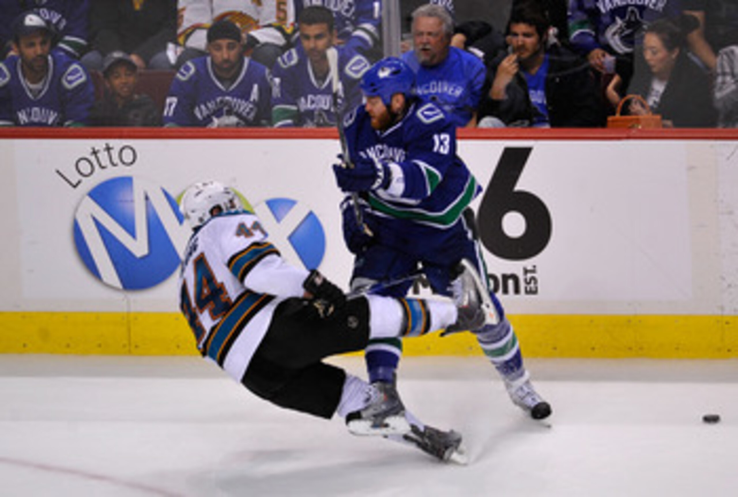 VANCOUVER, CANADA - MAY 15:  Raffi Torres #13 of the Vancouver Canucks checks Marc-Edouard Vlasic #44 of the San Jose Sharks in Game One of the Western Conference Finals during the 2011 Stanley Cup Playoffs at Rogers Arena on May 15, 2011 in Vancouver, Br
