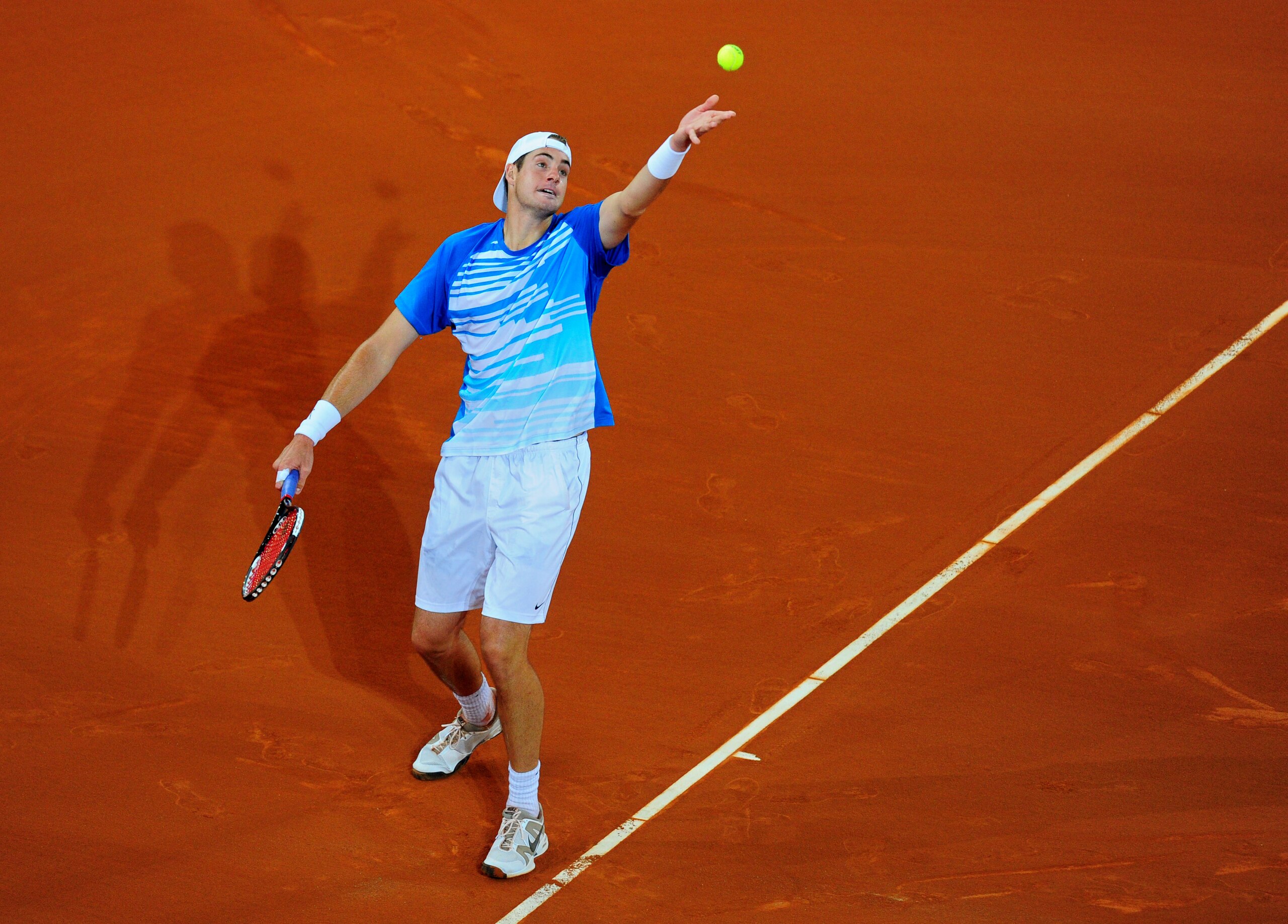 MADRID, SPAIN - MAY 13:  John Isner of the USA serves the ball to Rafael Nadal of Spain in his third round match during the Mutua Madrilena Madrid Open tennis tournament at the Caja Magica on May 13, 2010 in Madrid, Spain.  (Photo by Jasper Juinen/Getty I