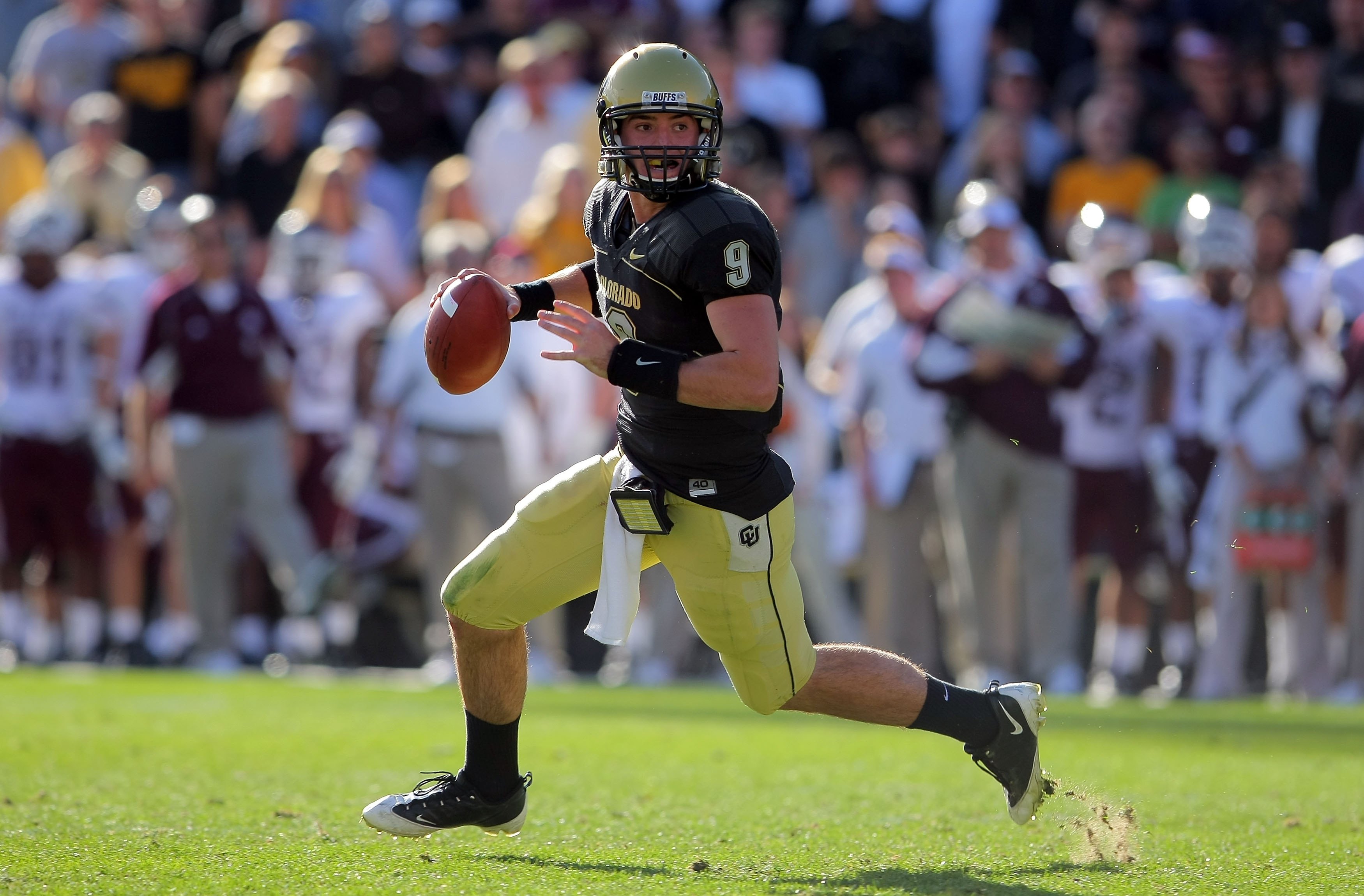 BOULDER, CO - NOVEMBER 07:  Quarterback Tyler Hansen #9 of the Colorado Buffaloes rolls out to deliver a pass against the Texas A&M Aggies during NCAA college football action at Folsom Field on November 7, 2009 in Boulder, Colorado. Colorado defeated Texa