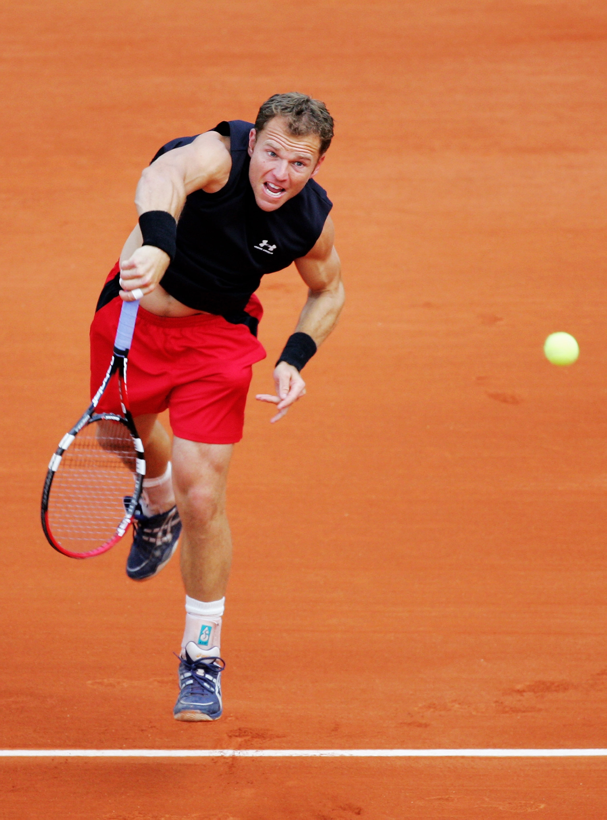 PARIS - MAY 29:  Michael Russell of United States of America in action against Roger Federer of Switzerland during the Men's Singles 1st round match on day three of the French Open at Roland Garros on May 29, 2007 in Paris, France.  (Photo by Mike Hewitt/
