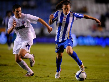 A CORUNA, SPAIN - AUGUST 14: Andres Guardado (R) of Deportivo La Coruna gets past Goran Rubil of Hadjuk Split during the UEFA Cup Second Qualifying Round, first leg match between Deportivo La Coruna and Hadjuk Split at the Riazor stadium on August 14, 200