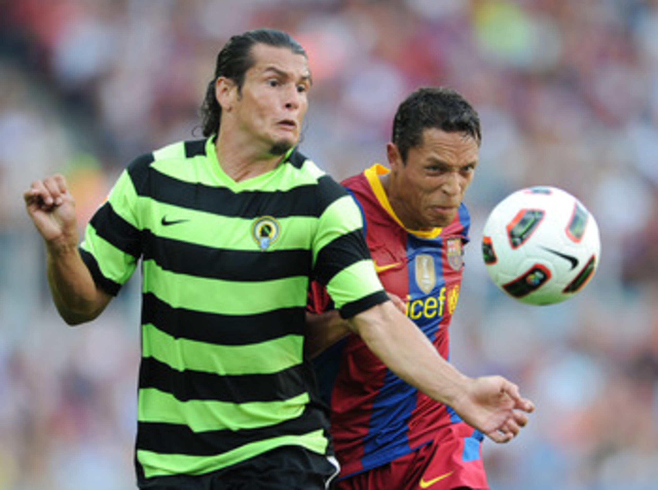 BARCELONA, SPAIN - SEPTEMBER 11:  Adriano (R) of Barcelona fights for the ball with Nelson Valdez of Hercules during the La Liga match between Barcelona and Hercules at the Camp Nou stadium on September 11, 2010 in Barcelona, Spain.  (Photo by Jasper Juin