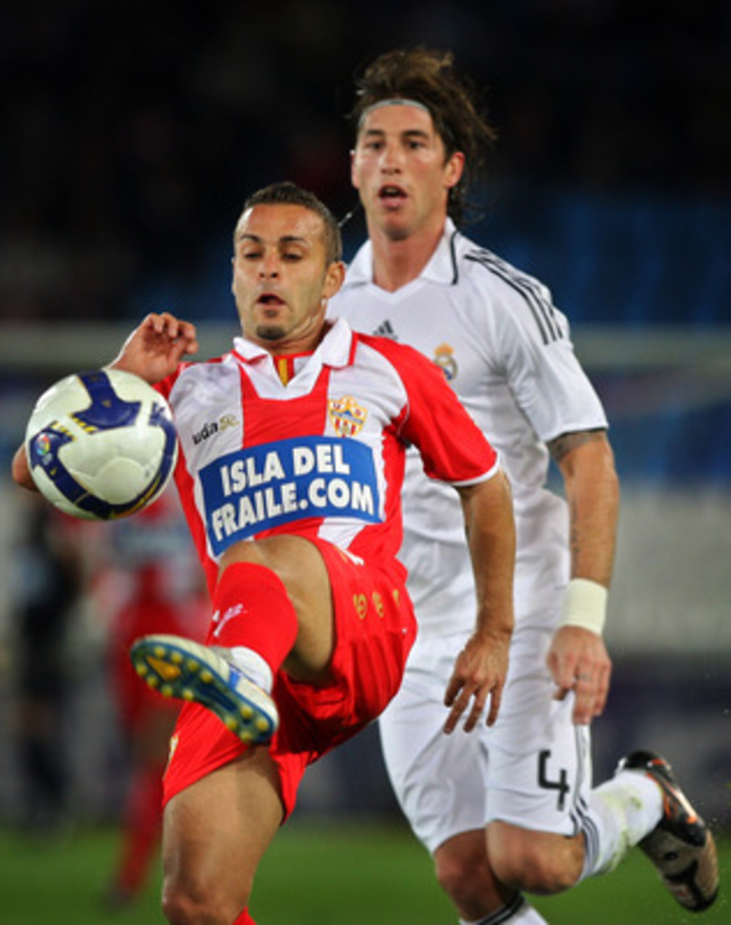 ALMERIA, SPAIN - NOVEMBER 02:  Albert Crusat Domene (L) of Almeria controls the ball in front Sergio Ramos of Real Madrid during the La Liga match between Almeria and Real Madrid at the Estadio de los Juegos Mediterraneos on November 2, 2008 in Almeria, S