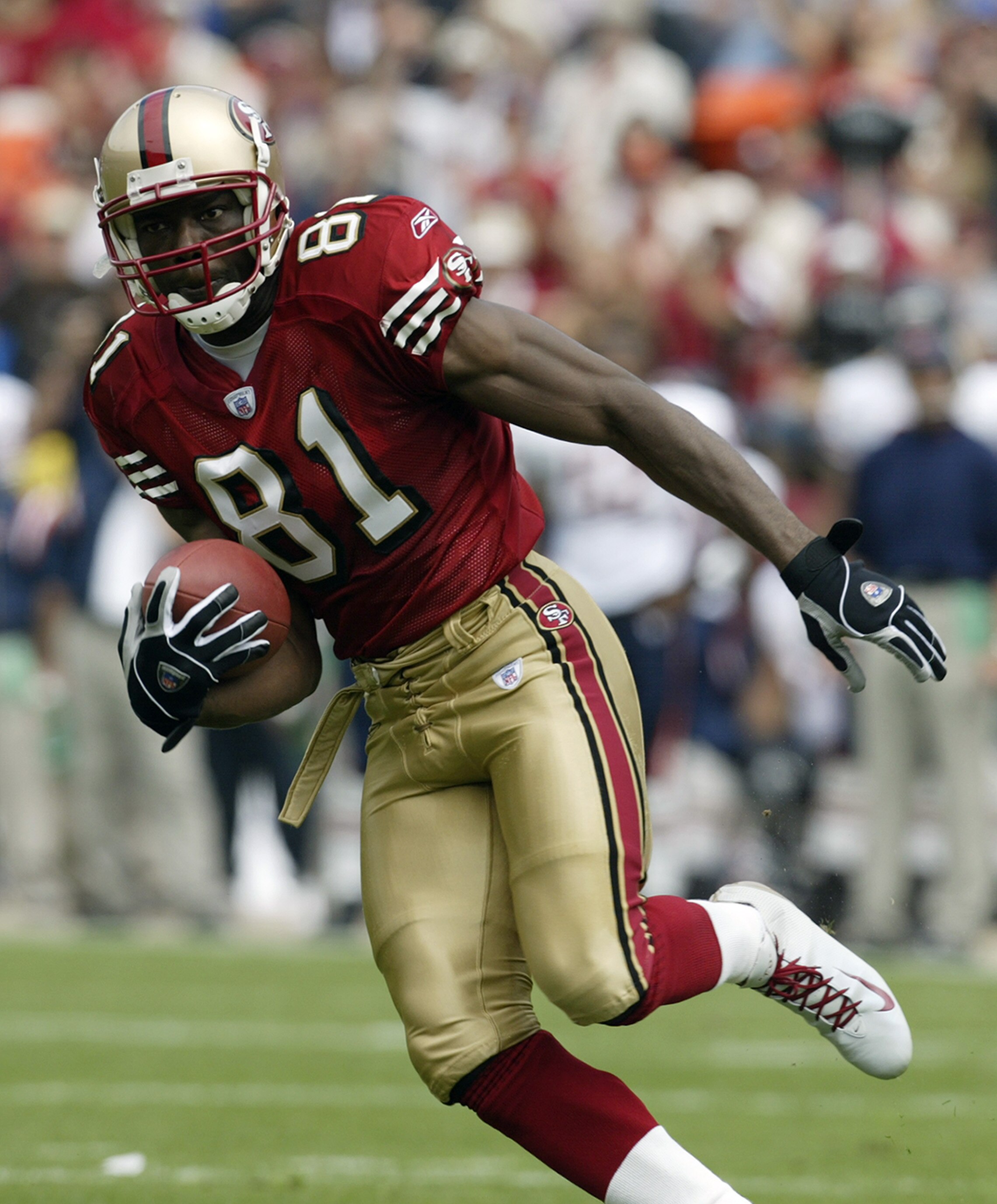 SAN FRANCISCO - SEPTEMBER 7:  Wide receiver Terrell Owens #81 of the San Francisco 49ers moves the ball   during the game against the Chicago Bears on September 7, 2003 at Candelstick Park in San Francisco, California. The 49ers defeated the Bears 49-7. (