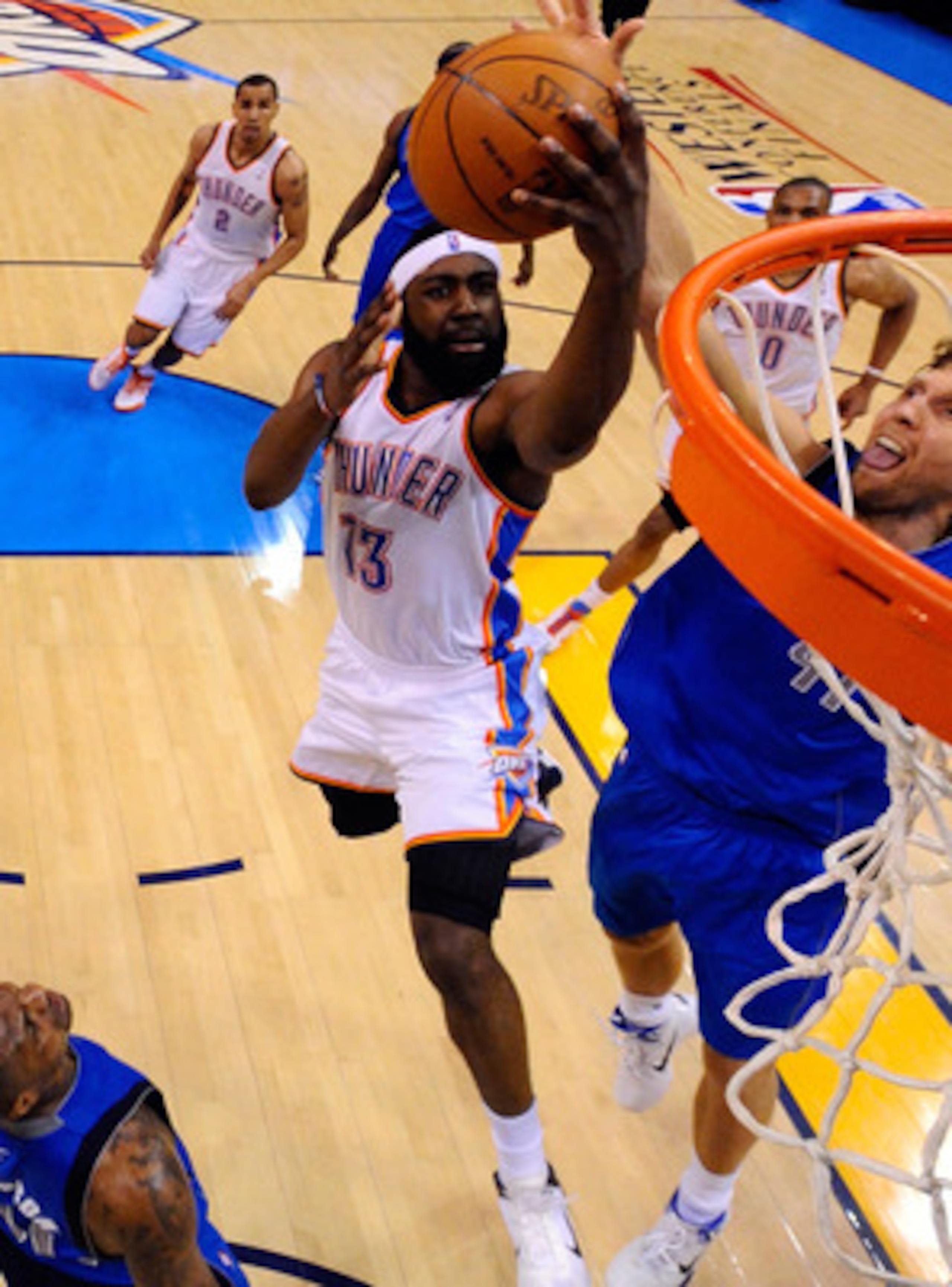 OKLAHOMA CITY, OK - MAY 21:  James Harden #13 of the Oklahoma City Thunder goes up for a shot against Dirk Nowitzki #41 of the Dallas Mavericks in the second half in Game Three of the Western Conference Finals during the 2011 NBA Playoffs at Oklahoma City