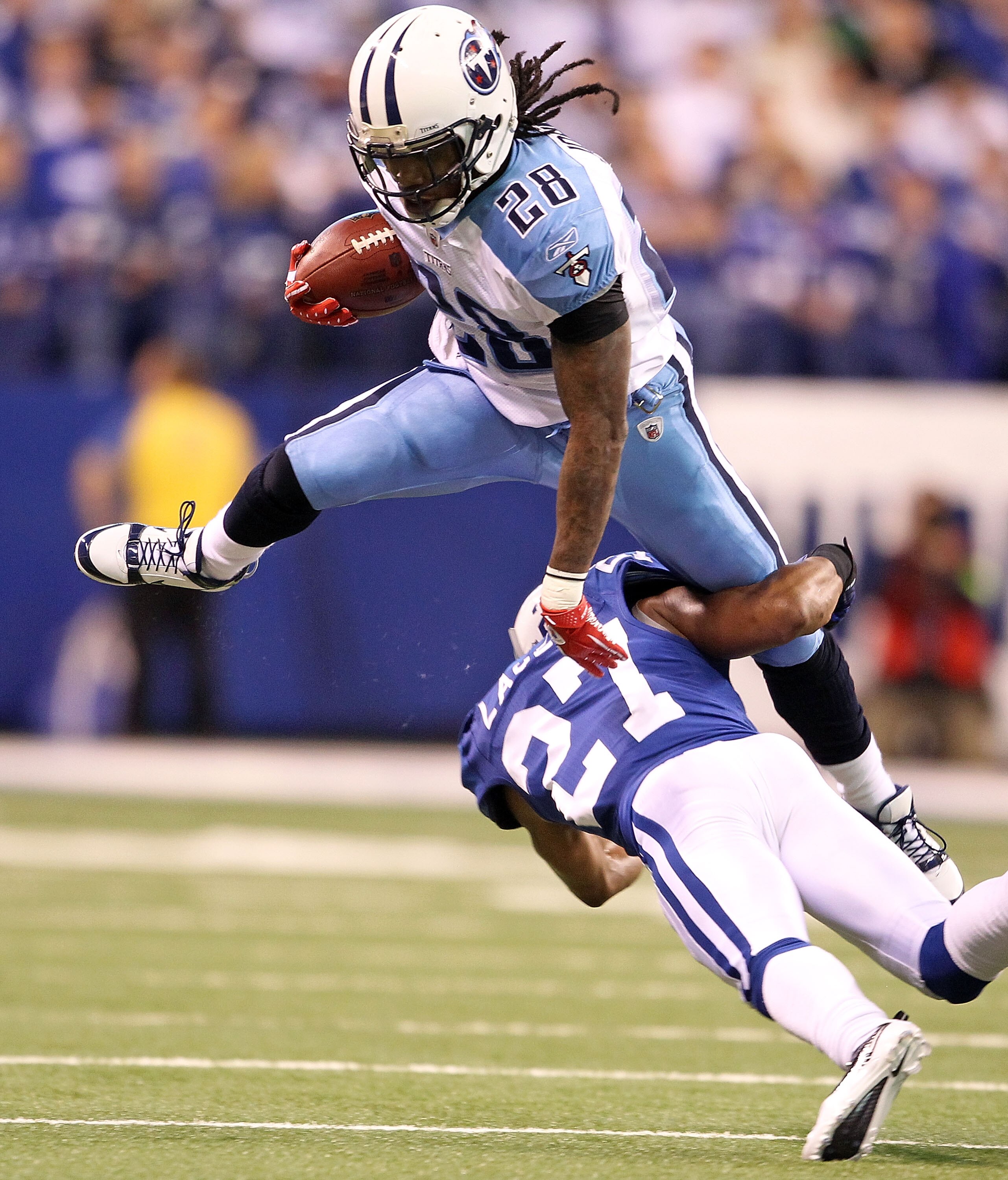 INDIANAPOLIS - JANUARY 02:  Chris Johnson #28 of the Tennessee Titans is tackled by Jacob Lacey #27 of the Indianapolis Colts at Lucas Oil Stadium on January 2, 2011 in Indianapolis, Indiana.  the Colts won 23-20.  (Photo by Andy Lyons/Getty Images)