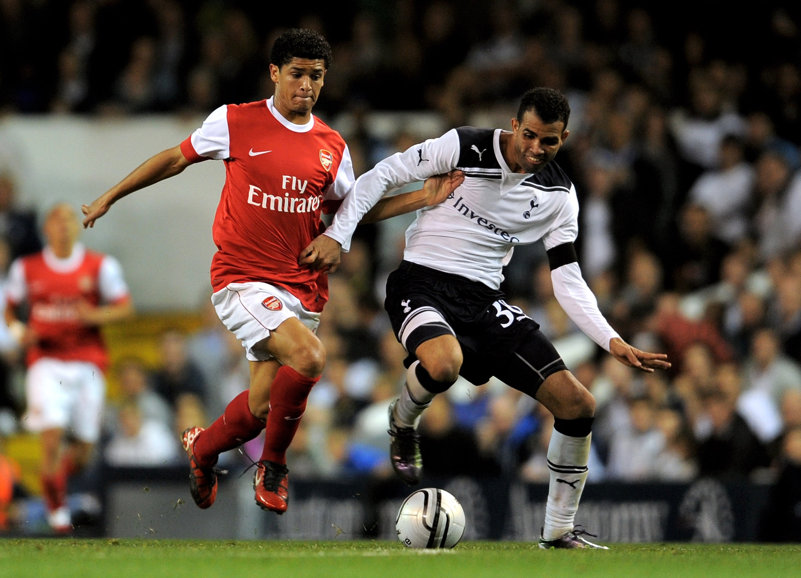 LONDON, ENGLAND - SEPTEMBER 21:  Denilson (L) of Arsenal and Sandro (R) of Spurs battle for the ball during the Carling Cup third round match between Tottenham Hotspur and Arsenal at White Hart Lane on September 21, 2010 in London, England.  (Photo by Mic
