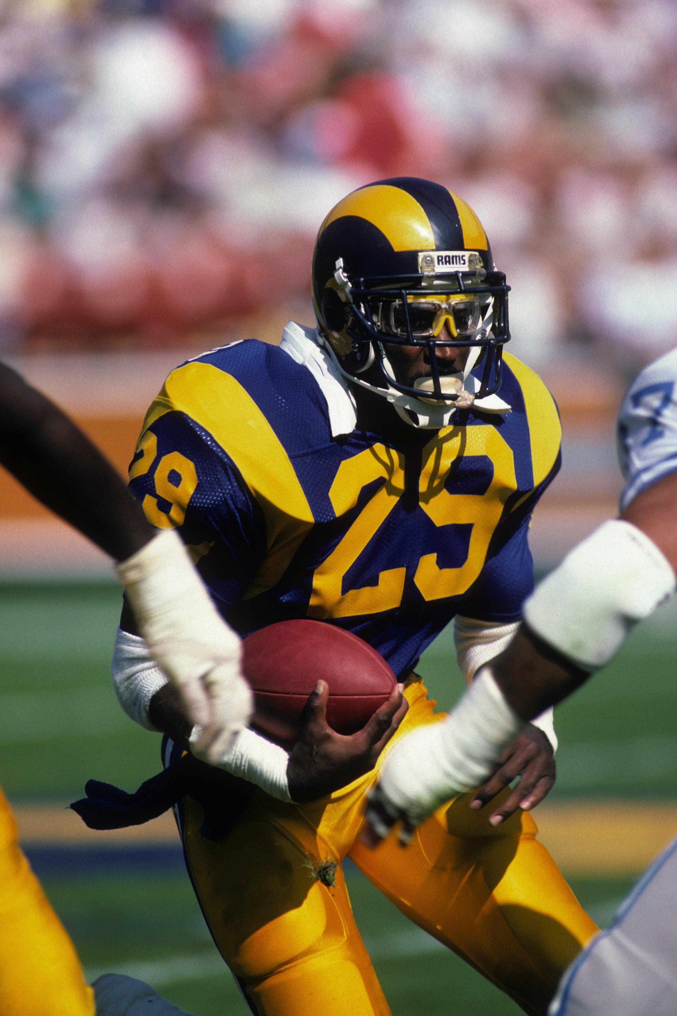 ANAHEIM, CA - OCTOBER 19:  Running back Eric Dickerson #28 of the Los Angeles Rams looks to make a move with the ball during the game against the Detroit Lions at Anaheim Stadium on October 19, 1986 in Anaheim, California.   The Rams won 14-10. (Photo by