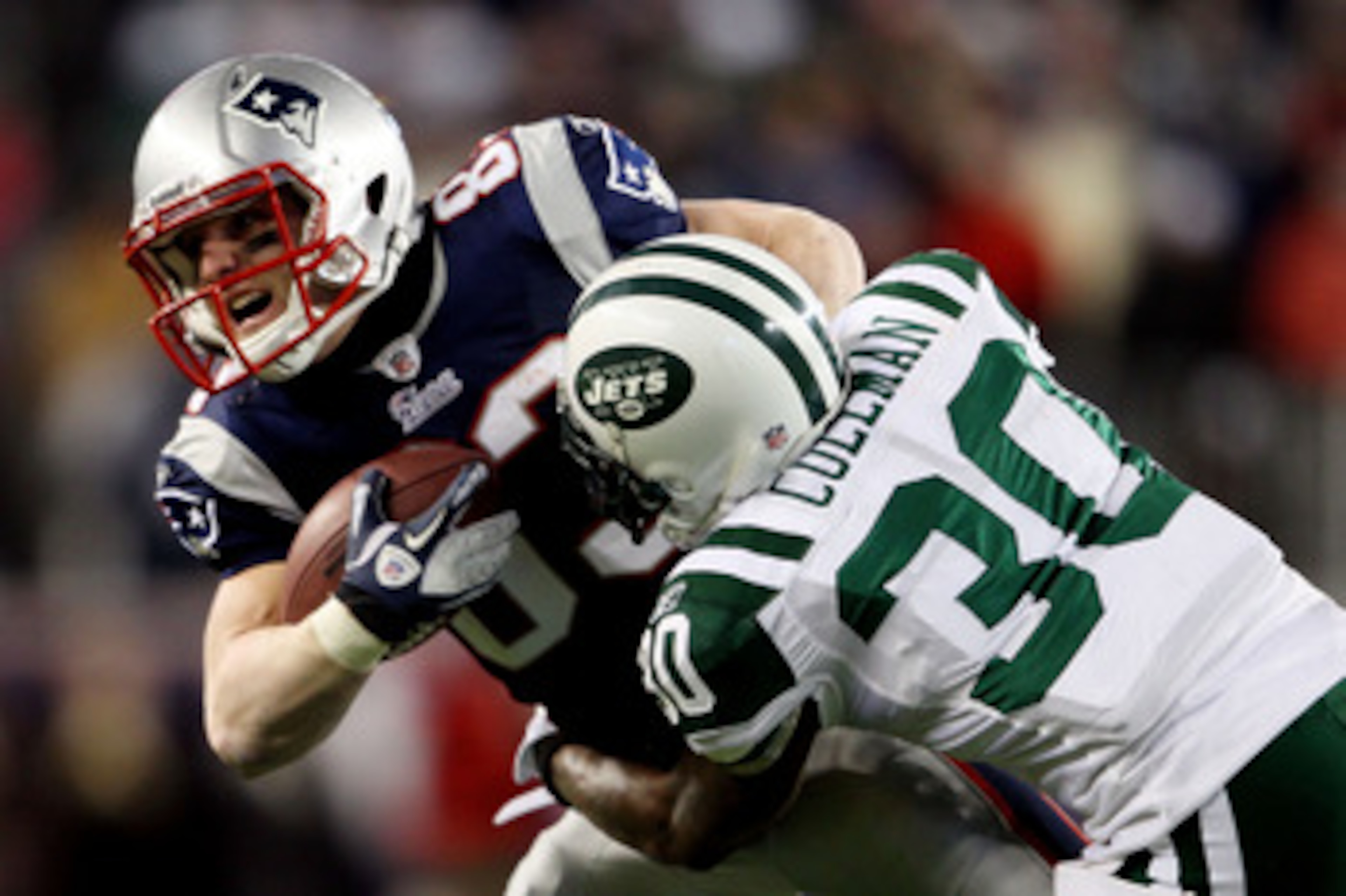 FOXBORO, MA - JANUARY 16:  Drew Coleman #30 of the New York Jets tackles Wes Welker #83 of the New England Patriots during their 2011 AFC divisional playoff game at Gillette Stadium on January 16, 2011 in Foxboro, Massachusetts.  (Photo by Elsa/Getty Imag
