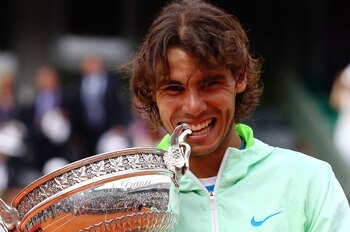 PARIS - JUNE 06:  Rafael Nadal of Spain celebrates with the trophy after winning the men's singles final match between Rafael Nadal of Spain and Robin Soderling of Sweden on day fifteen of the French Open at Roland Garros on June 6, 2010 in Paris, France.