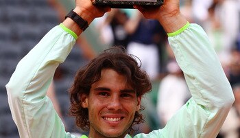 PARIS - JUNE 06:  Rafael Nadal of Spain celebrates with the trophy after winning the men's singles final match between Rafael Nadal of Spain and Robin Soderling of Sweden on day fifteen of the French Open at Roland Garros on June 6, 2010 in Paris, France.