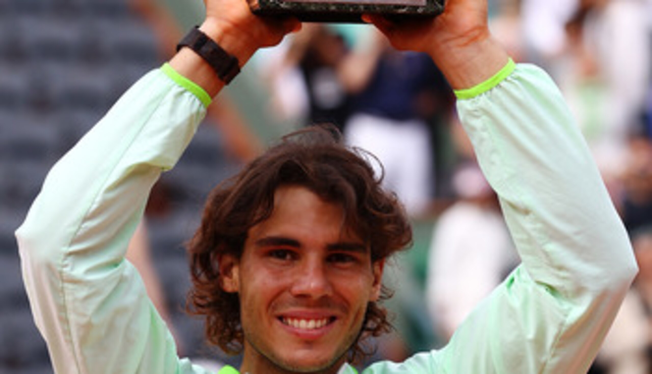 PARIS - JUNE 06: Rafael Nadal of Spain celebrates with the trophy after winning the men's singles final match between Rafael Nadal of Spain and Robin Soderling of Sweden on day fifteen of the French Open at Roland Garros on June 6, 2010 in Paris, France. PARIS - JUNE 06: Rafael Nadal of Spain celebrates with the trophy after winning the men's singles final match between Rafael Nadal of Spain and Robin Soderling of Sweden on day fifteen of the French Open at Roland Garros on June 6, 2010 in Paris, France.