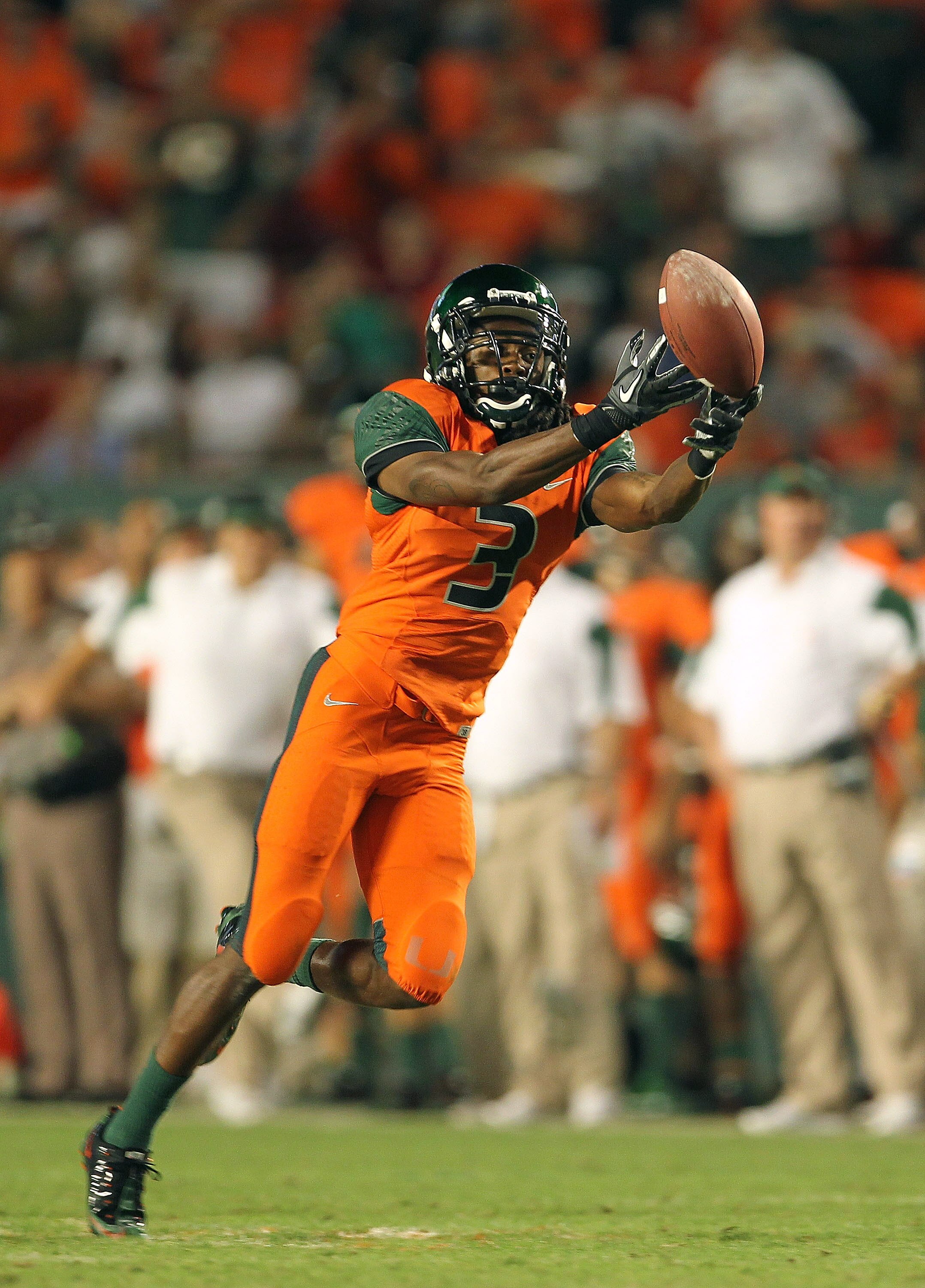 MIAMI - NOVEMBER 20:  Travis Benjamin #3 of the Miami Hurricanes misses a fingertip catch during a game against the Virginia Tech Hokies at Sun Life Stadium on November 20, 2010 in Miami, Florida.  (Photo by Mike Ehrmann/Getty Images)