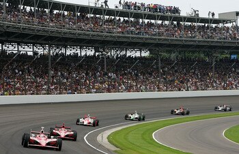 INDIANAPOLIS - MAY 27:  Scott Dixon, driver of the #9 Target Chip Ganassi Racing Dallara Honda, leads Dan Wheldon, driver of the #10 Chip Ganassi Racing Dallara Honda and Sam Hornish Jr., driver of the #6 Team Penske Dallara Honda, during the IRL IndyCar