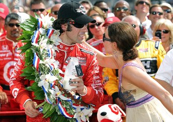 INDIANAPOLIS - MAY 30:  Dario Franchitti of Scotland, driver of the #10 Target Chip Ganassi Racing Dallara Honda, celebrates with his wife Ashley Judd in victory lane after winning the IZOD IndyCar Series 94th running of the Indianapolis 500 at the Indian