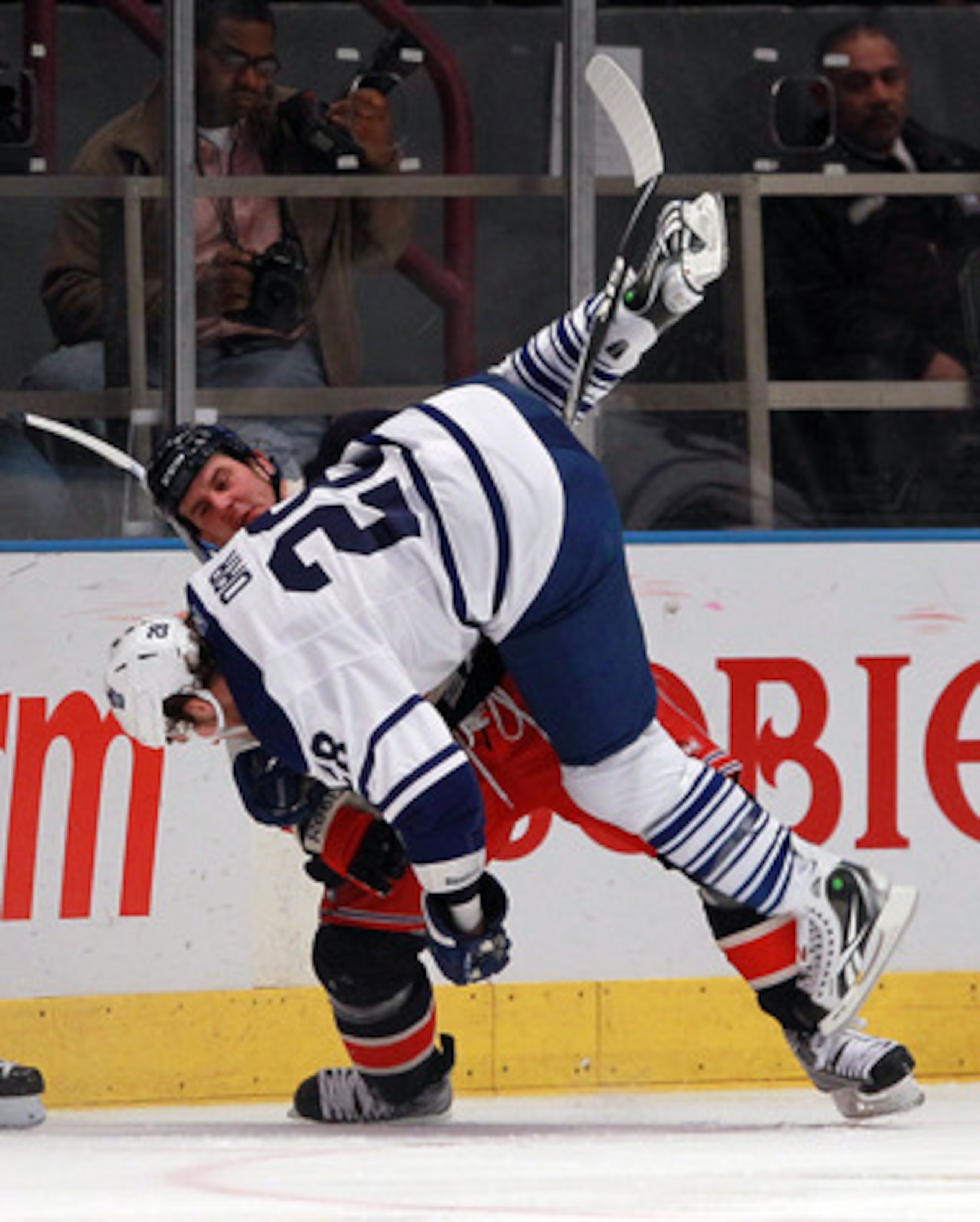 NEW YORK, NY - JANUARY 19:  Colton Orr #28 of the Toronto Maple Leafs is flipped over by Kris Newbury #45 of the New York Rangers during the first period at Madison Square Garden on January 19, 2011 in New York City.  (Photo by Bruce Bennett/Getty Images)