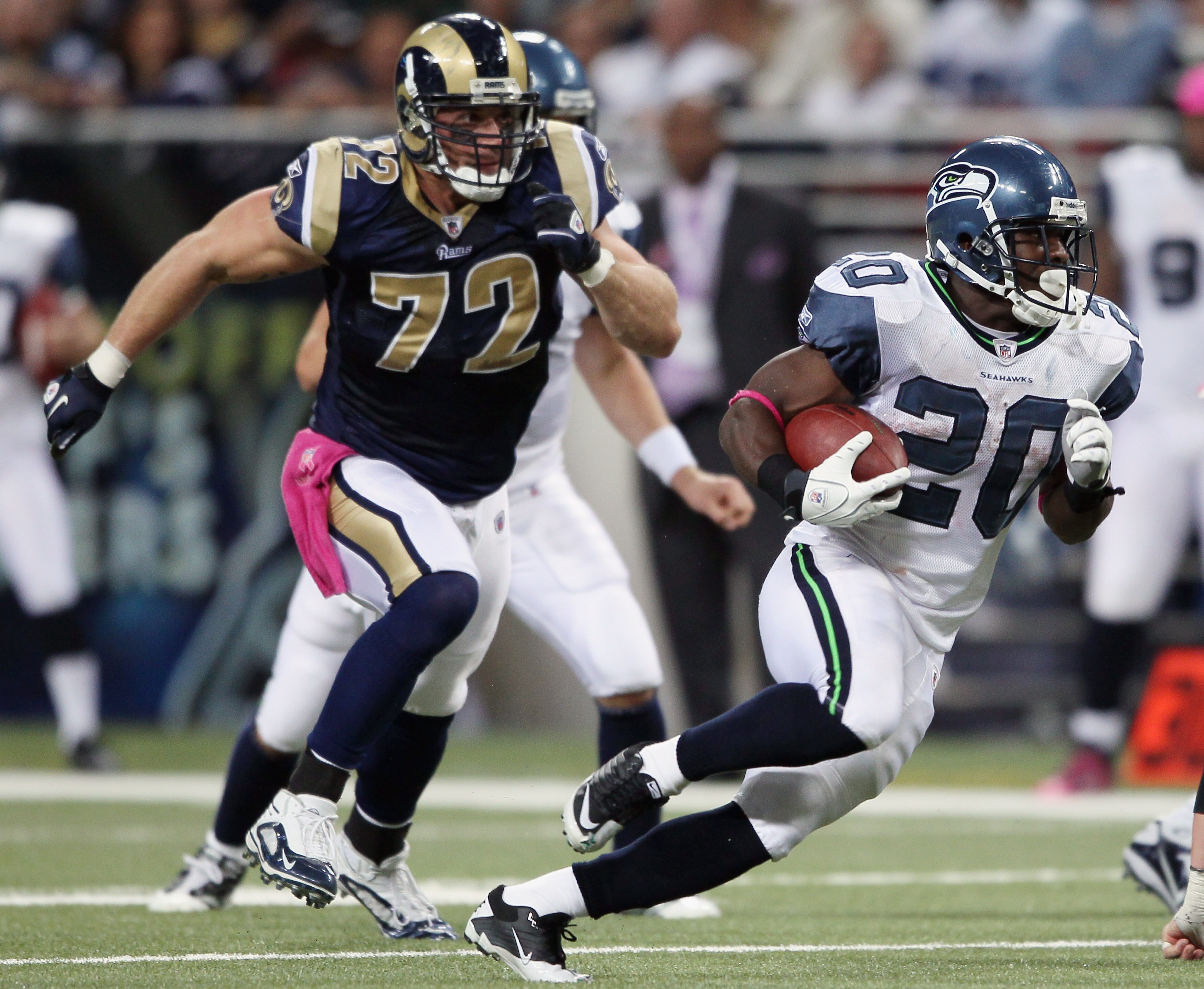 ST. LOUIS - OCTOBER 03:  Justinn Forsett #20 of the Seattle Seahawks carries the ball as Chris Long #72 of the St. Louis Rams defends on October 3, 2010 at Edward Jones Dome in St. Louis, Missouri.  (Photo by Elsa/Getty Images)