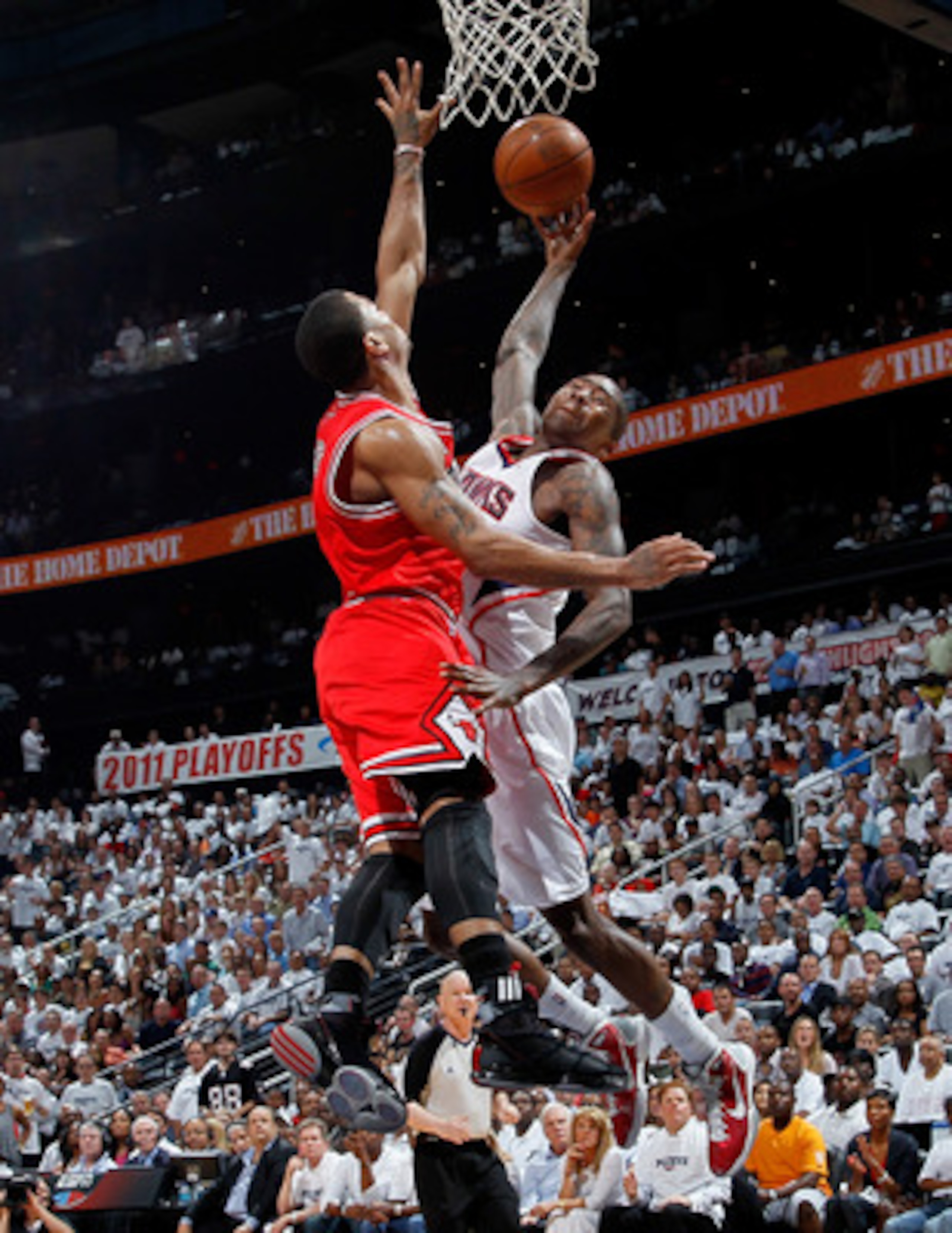 ATLANTA, GA - MAY 12:  Derrick Rose #1 of the Chicago Bulls defends a dunk by Jamal Crawford #11 of the Atlanta Hawks in Game Six of the Eastern Conference Semifinals in the 2011 NBA Playoffs at Phillips Arena on May 12, 2011 in Atlanta, Georgia.  NOTE TO