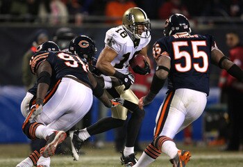 CHICAGO - DECEMBER 11:  Lance Moore #16 of the New Orleans Saints runs with the ball against Tommie Harris #91 and Lance Briggs #55 of the Chicago Bears at Soldier Field on December 11, 2008 in Chicago, Illinois.  (Photo by Jonathan Daniel/Getty Images)