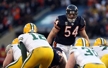 CHICAGO, IL - JANUARY 23:  Brian Urlacher #54 of the Chicago Bears looks over at Aaron Rodgers #12 of the Green Bay Packers before the snap in the NFC Championship Game at Soldier Field on January 23, 2011 in Chicago, Illinois.  (Photo by Doug Pensinger/G