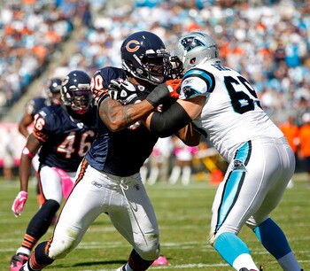 CHARLOTTE, NC - OCTOBER 10: Offensive tackle Jordan Gross #69 of the Carolina Panthers blocks defensive end Julius Peppers #90 of the Chicago Bears at Bank of America Stadium on October 10, 2010 in Charlotte, North Carolina. (Photo by Geoff Burke/Getty Im