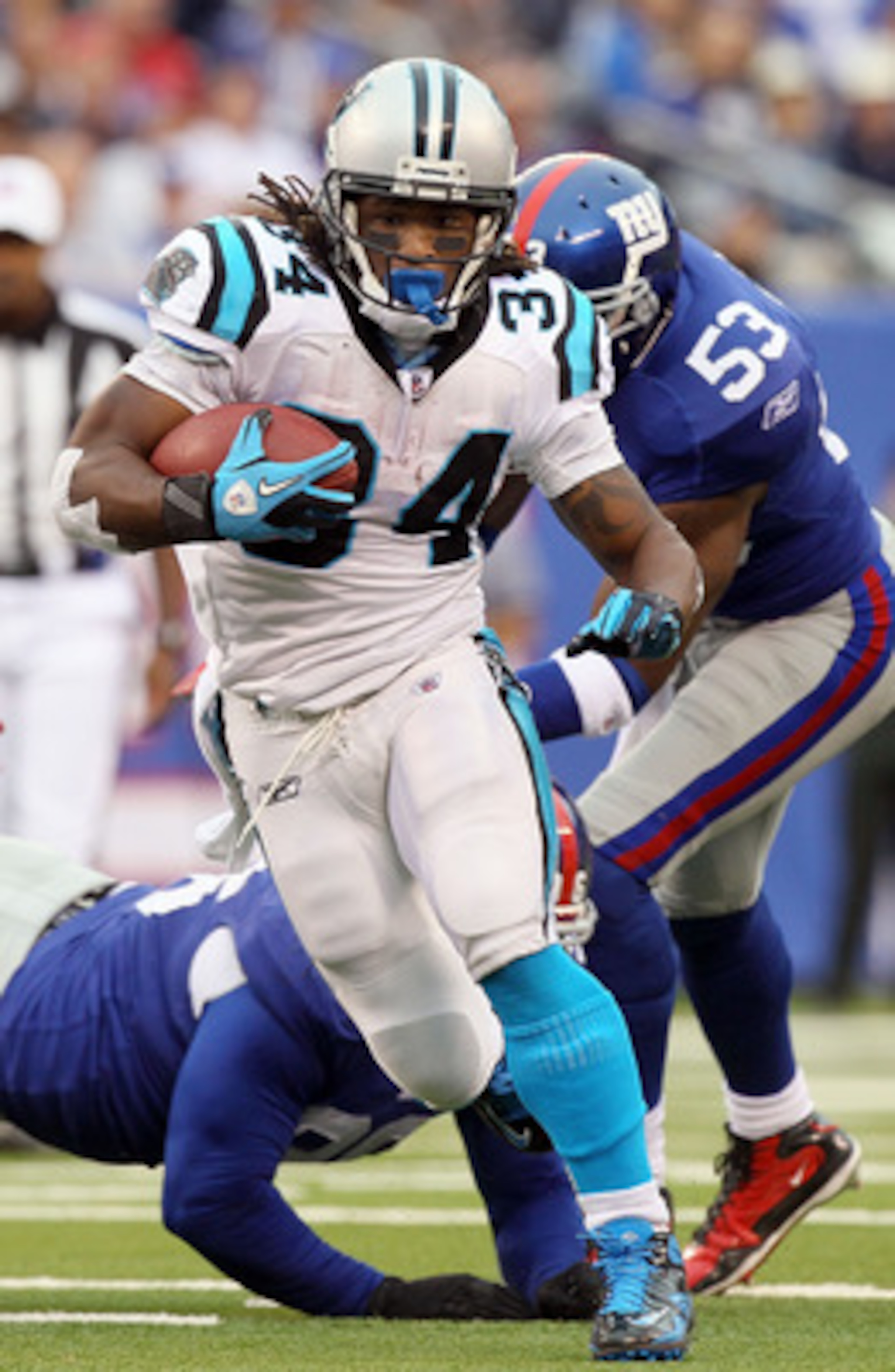 EAST RUTHERFORD, NJ - SEPTEMBER 12:  DeAngelo Williams #34 of the Carolina Panthers runs the ball in the first half against the New York Giants on September 12, 2010 at the New Meadowlands Stadium in East Rutherford, New Jersey.  (Photo by Jim McIsaac/Get