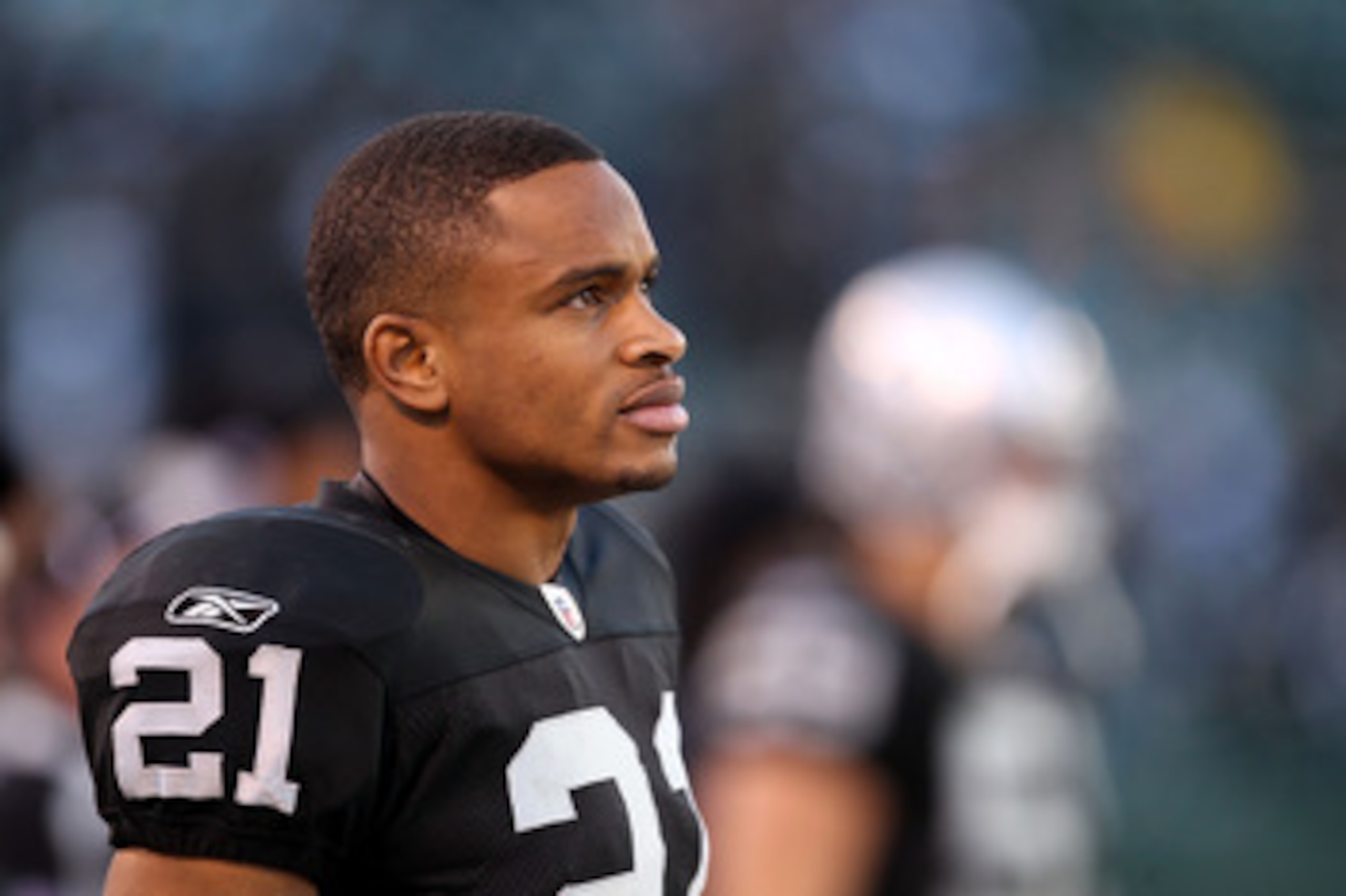 OAKLAND, CA - NOVEMBER 28:  Nnamdi Asomugha #21 of the Oakland Raiders stands on the sidelines during the closing minutes of their loss to the Miami Dolphins at Oakland-Alameda County Coliseum on November 28, 2010 in Oakland, California.  (Photo by Ezra S
