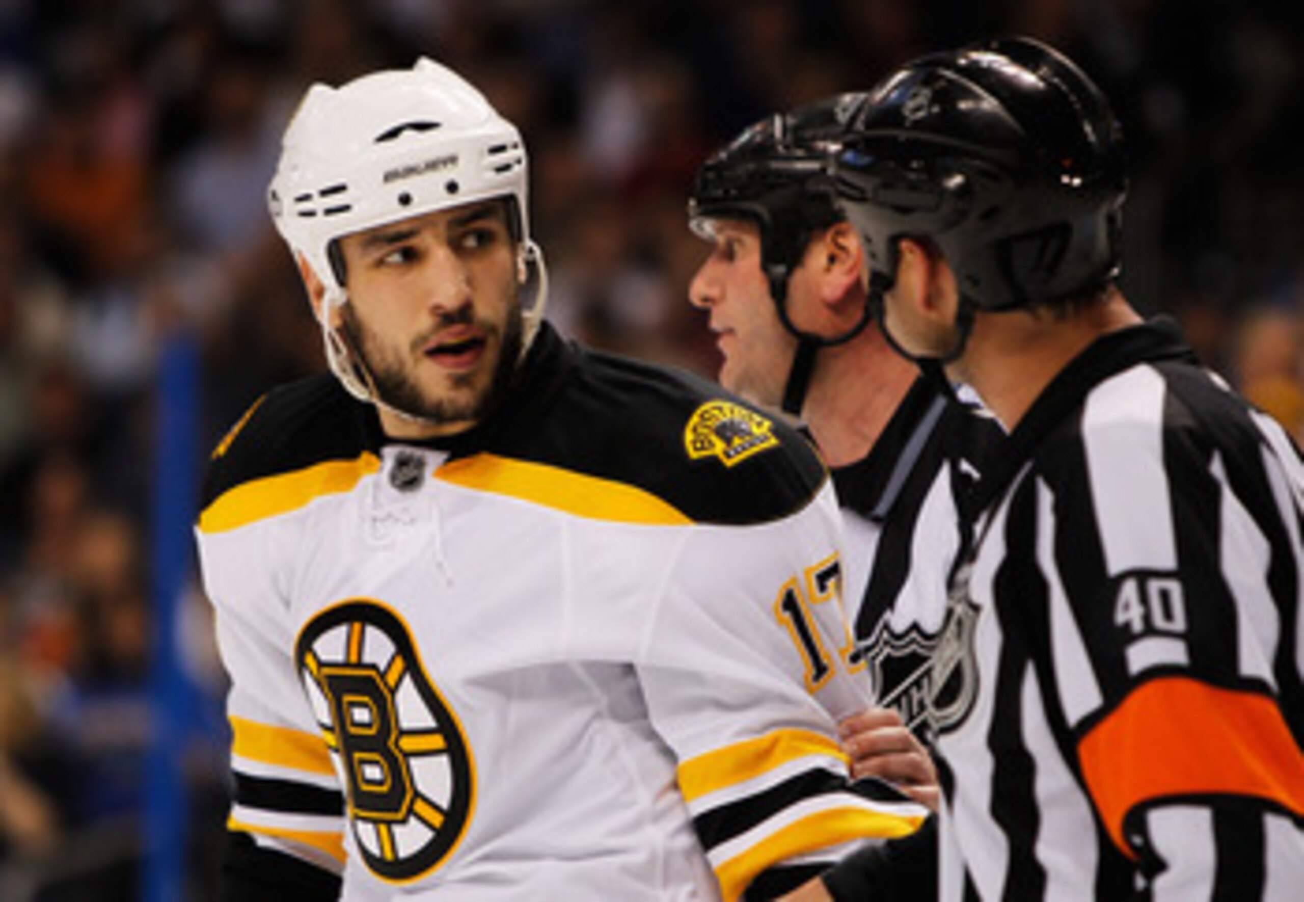 TAMPA, FL - MAY 19:  Milan Lucic #17 of the Boston Bruins talks to referee Steve Kozari #40 in Game Three of the Eastern Conference Finals against the Tampa Bay Lightning during the 2011 NHL Stanley Cup Playoffs at St Pete Times Forum on May 19, 2011 in T